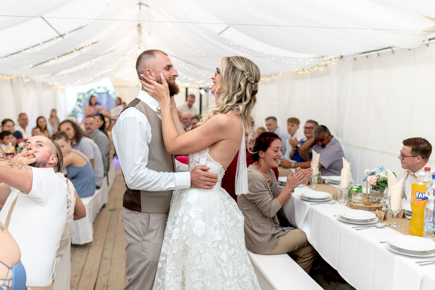A collage of wedding reception moments showing dancing, dining and celebration under a white tent.