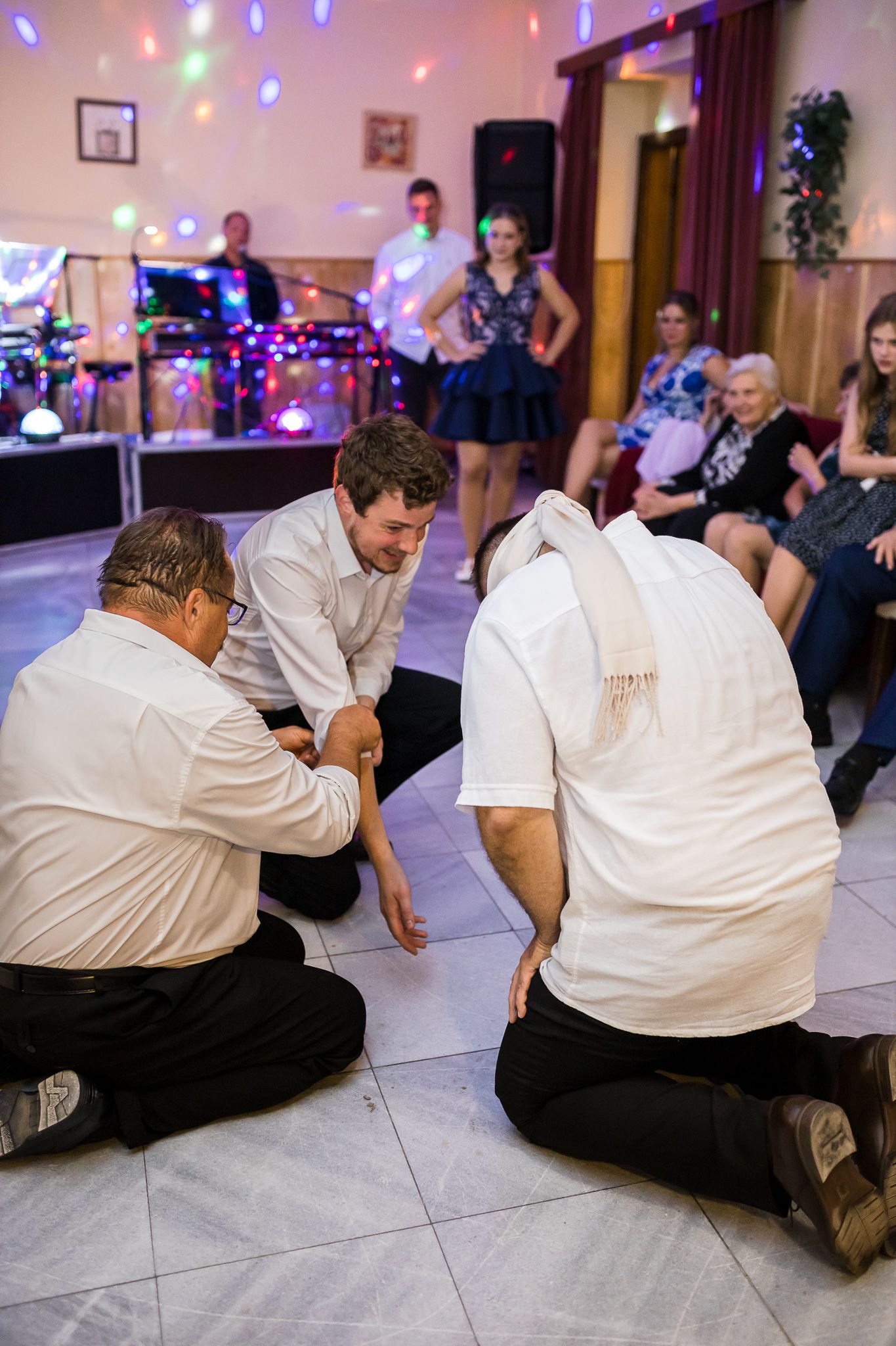 A sequence of dance floor photos showing people doing the limbo dance at a party with colorful lights in the background.