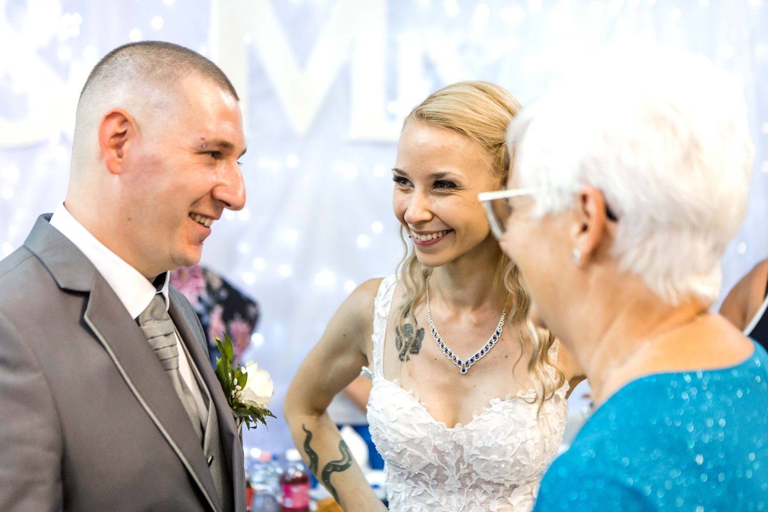 A joyful moment captured during an elegant wedding ceremony with guests in formal attire.