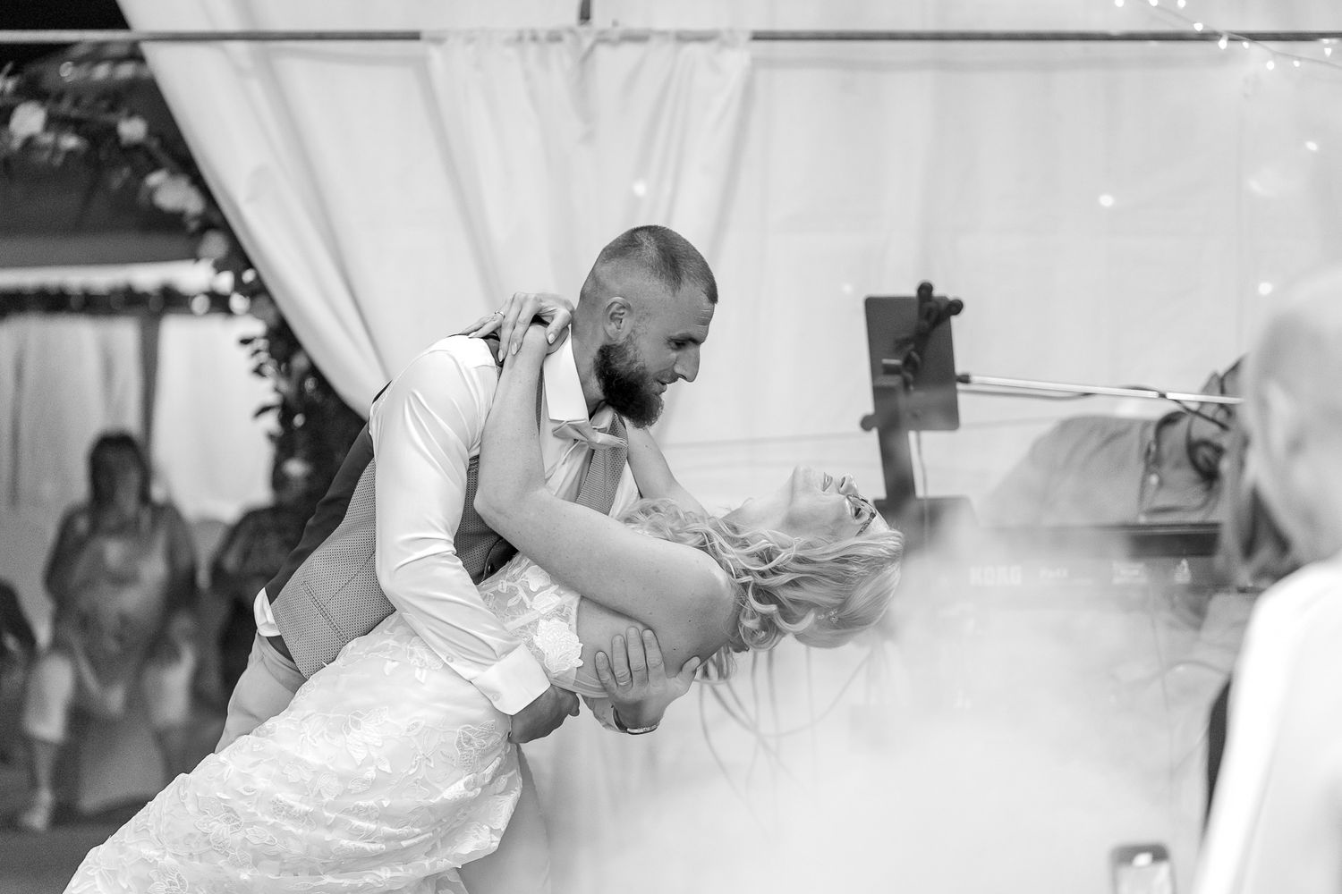 A series of black and white wedding photos showing intimate moments between a couple during their celebration.