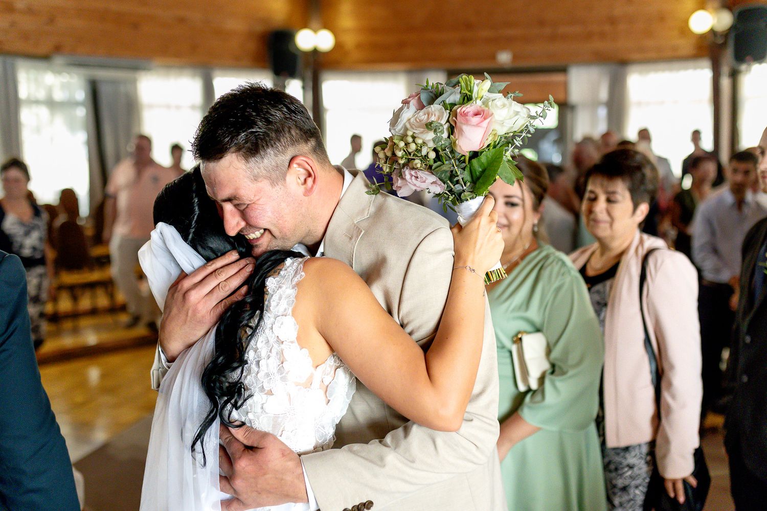 A romantic wedding couple shares intimate kisses and embraces in a series of candid reception photos.