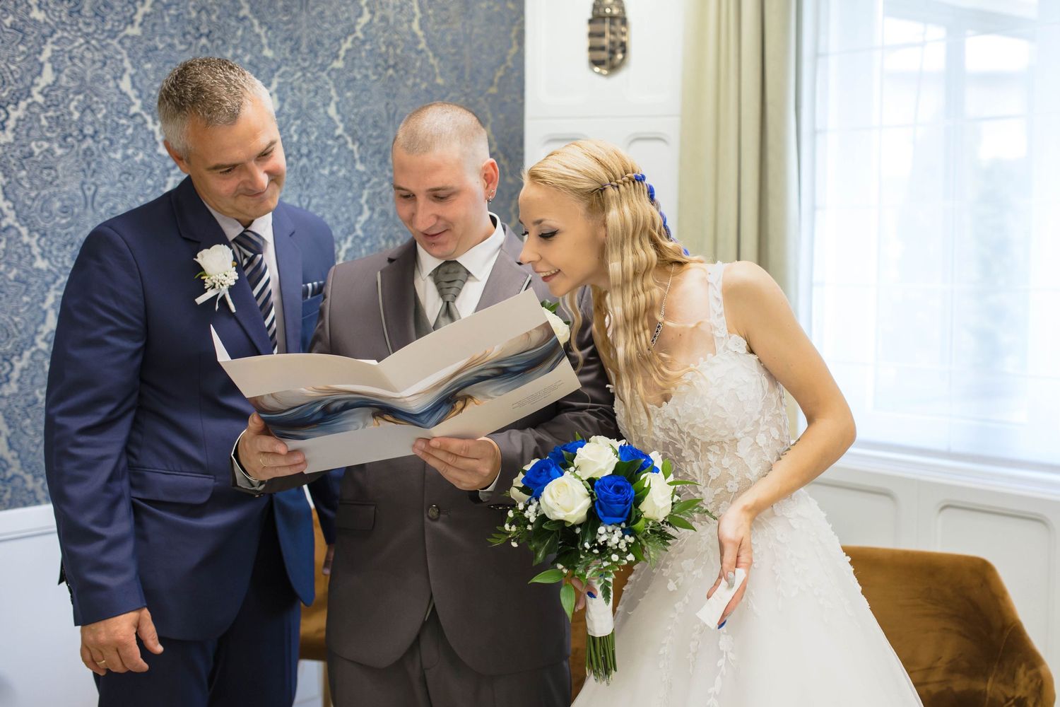 Bride and groom share intimate moments during their wedding ceremony in an elegant indoor venue with natural lighting.