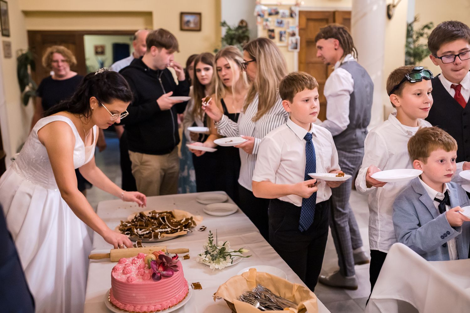 A series of wedding reception photos showing guests dancing, dining and celebrating at tables in an indoor venue.