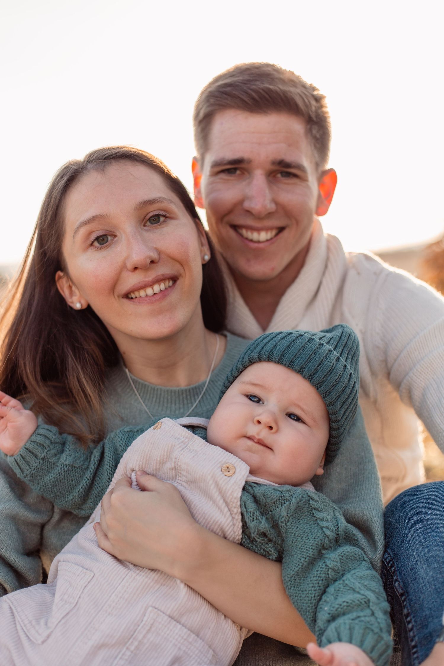 Close-up family portrait with soft natural lighting and gentle expressions.