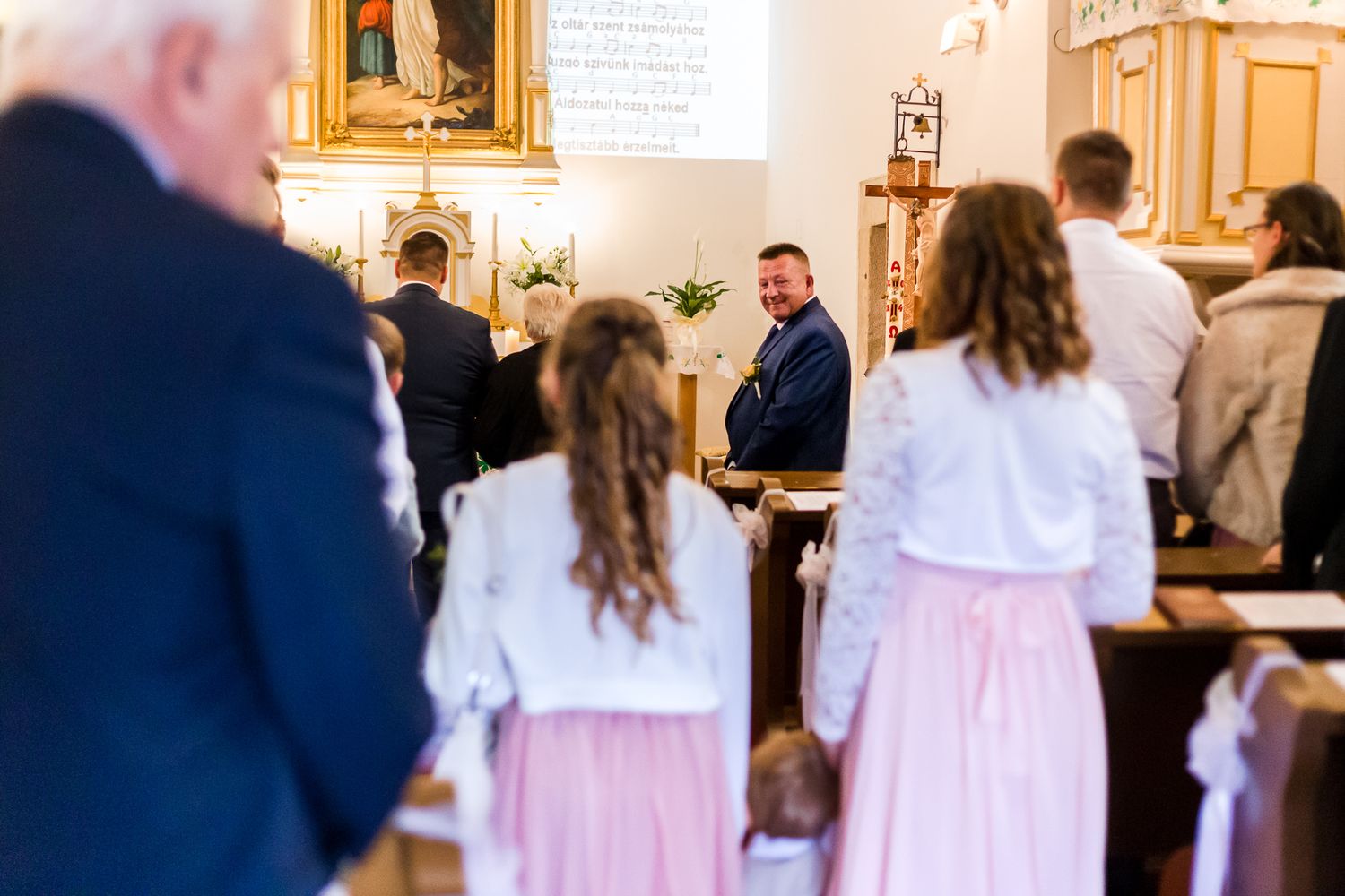 A sequence of photos showing a traditional Catholic First Communion ceremony in a church with ornate decor.