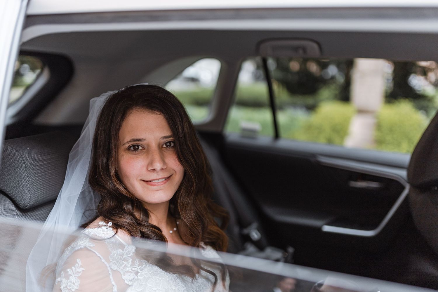 A series of wedding photos showing a bride in a white dress entering and sitting in a classic car.
