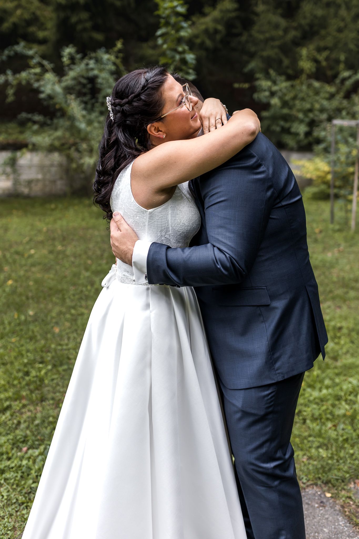 A romantic sequence of wedding photos shows a couple in white dress and navy suit embracing outdoors in a garden setting.
