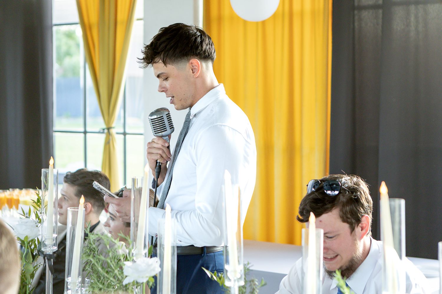Candid moments from a wedding reception with yellow curtains and modern decor.