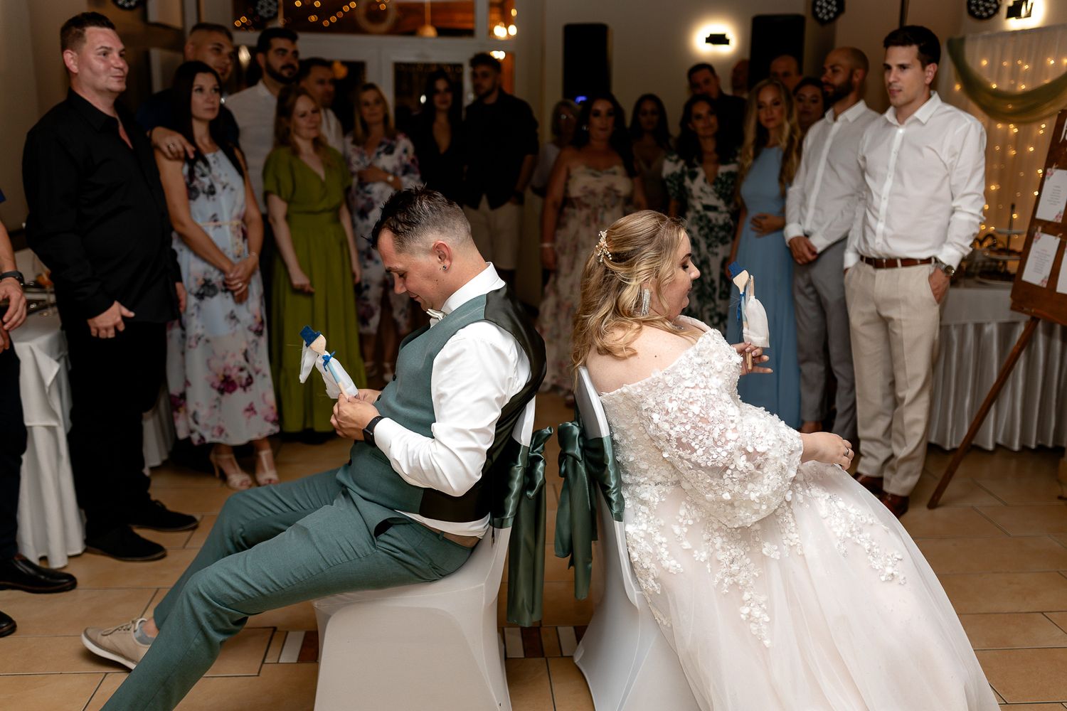 Wedding guests dance and celebrate together on a festively decorated reception dance floor.
