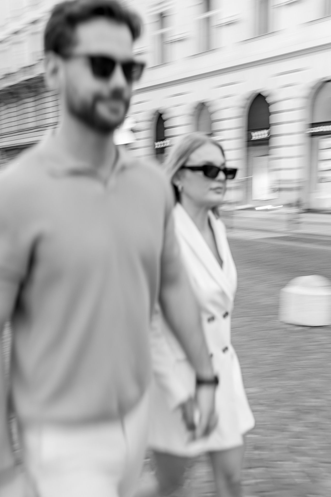 Blurred motion shot of a couple walking along an urban street.