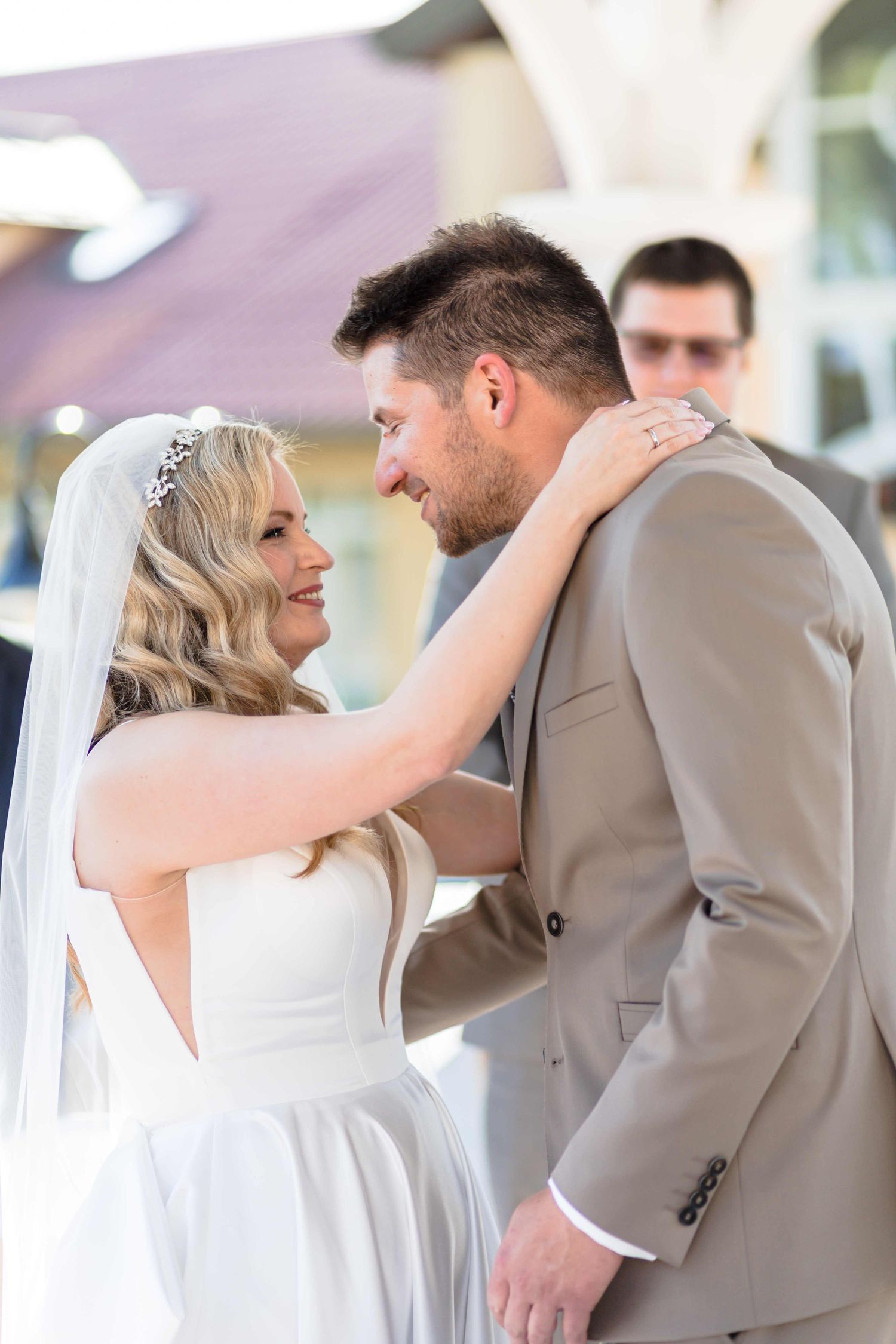 A series of candid wedding photos showing a couple sharing intimate moments during their first look in formal attire.