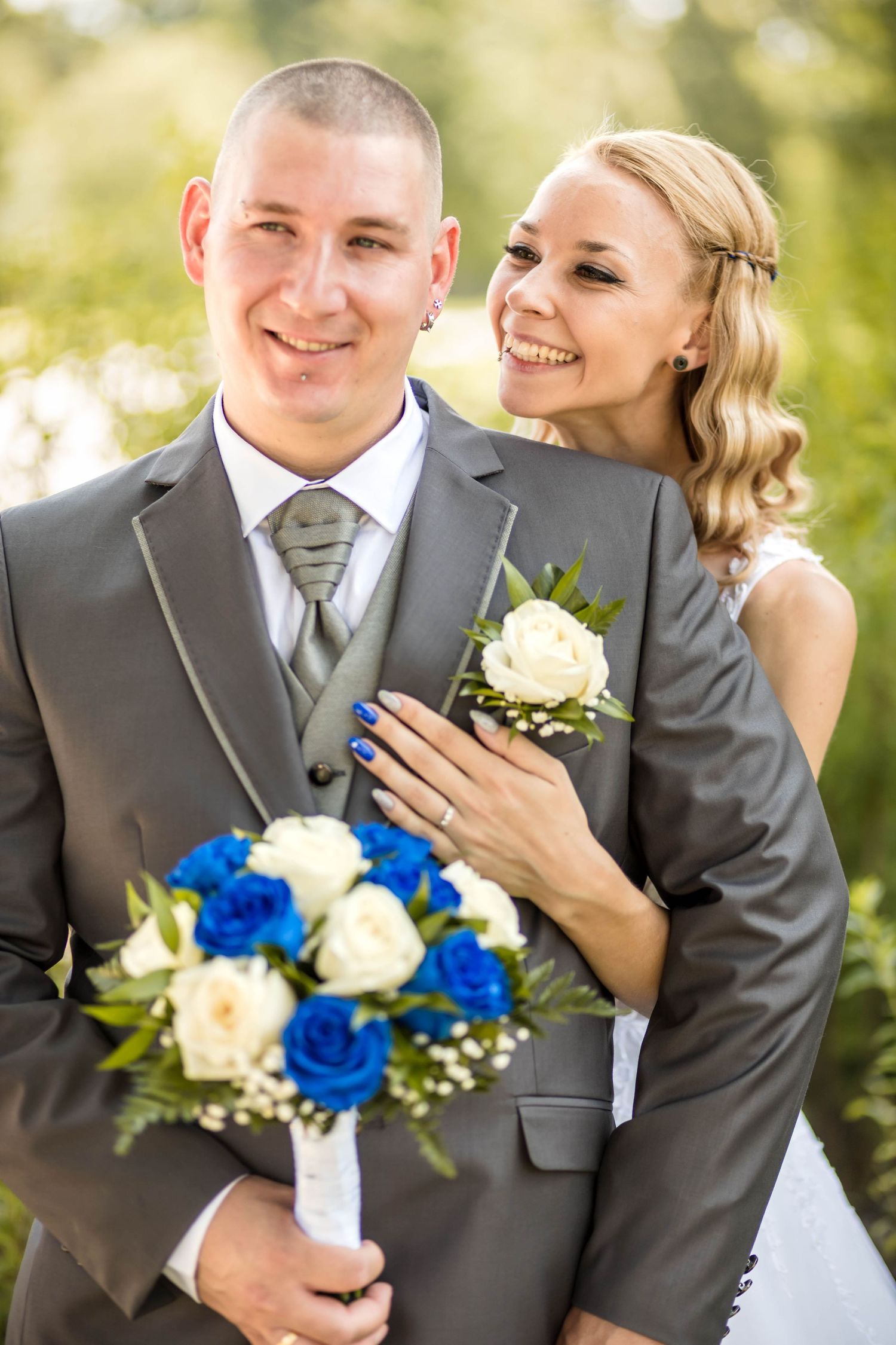 Wedding couple shares intimate moments in a series of outdoor portraits with blue and white floral bouquet.