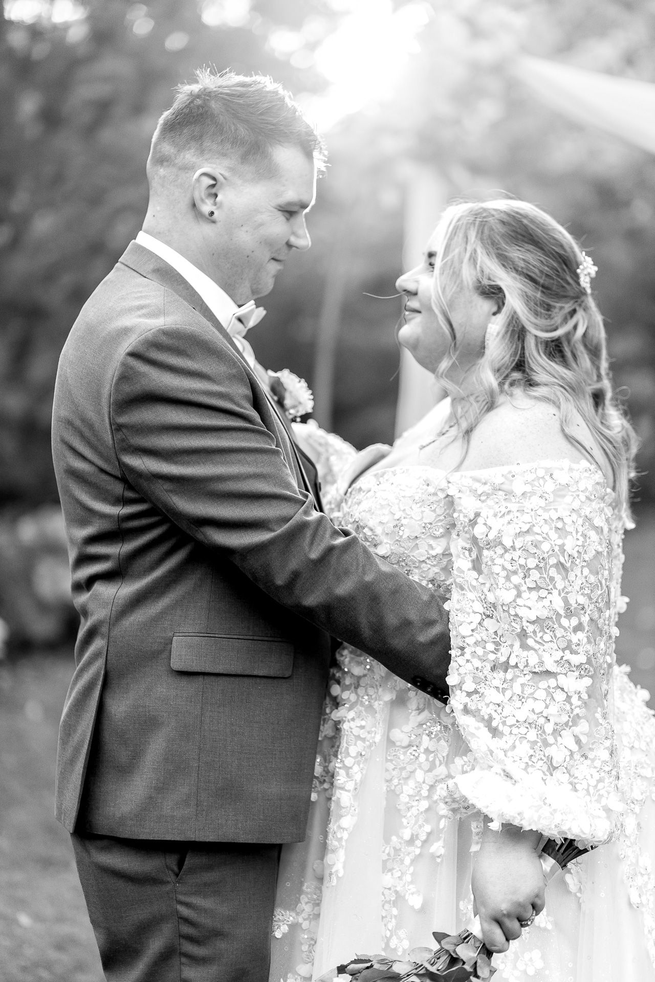 Black and white photo series showing intimate wedding couple moments with bride in lace gown and groom in dark suit.