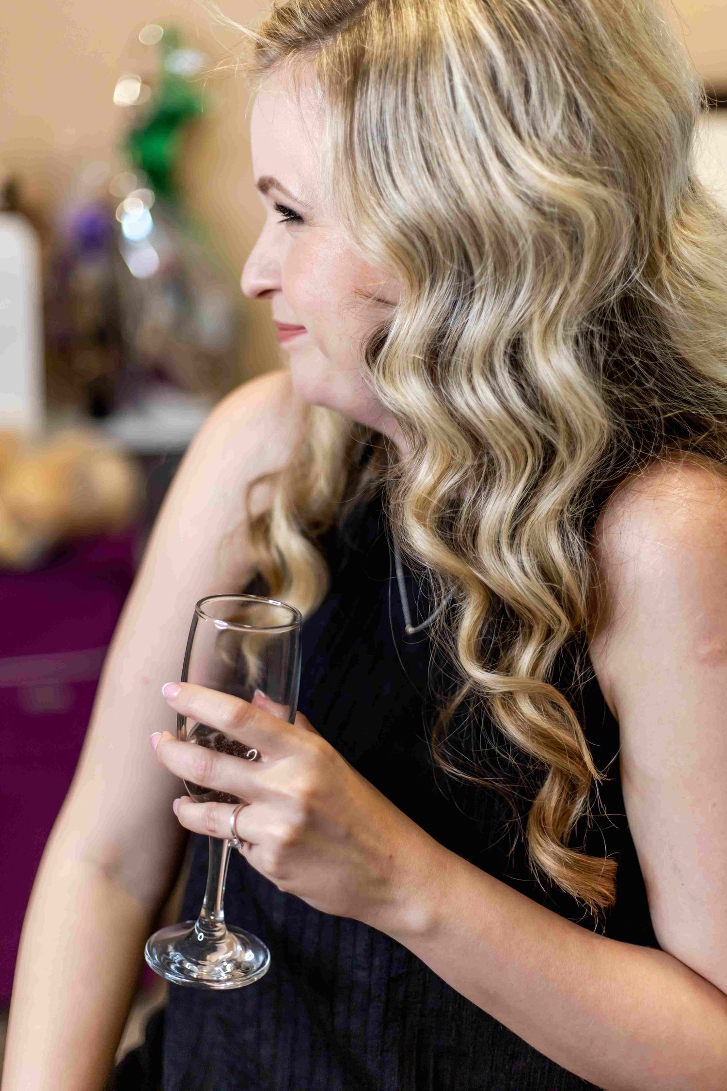 A person with wavy blonde hair sips from a wine glass in a series of progressive shots.