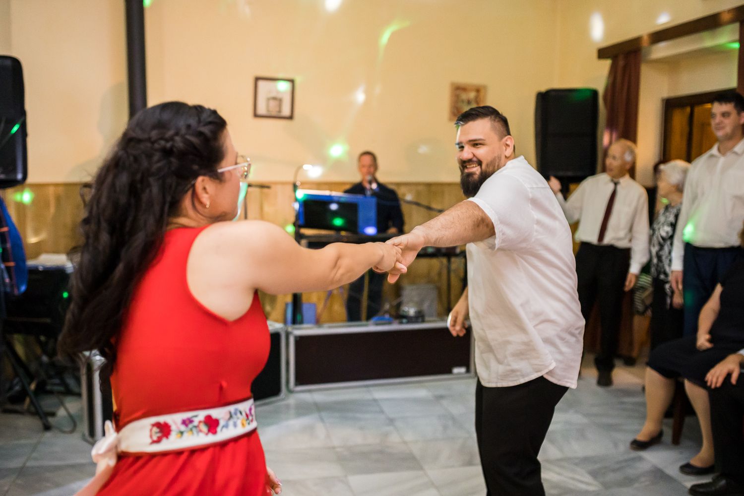 People dancing together in a group setting at what appears to be a social dance class or gathering.