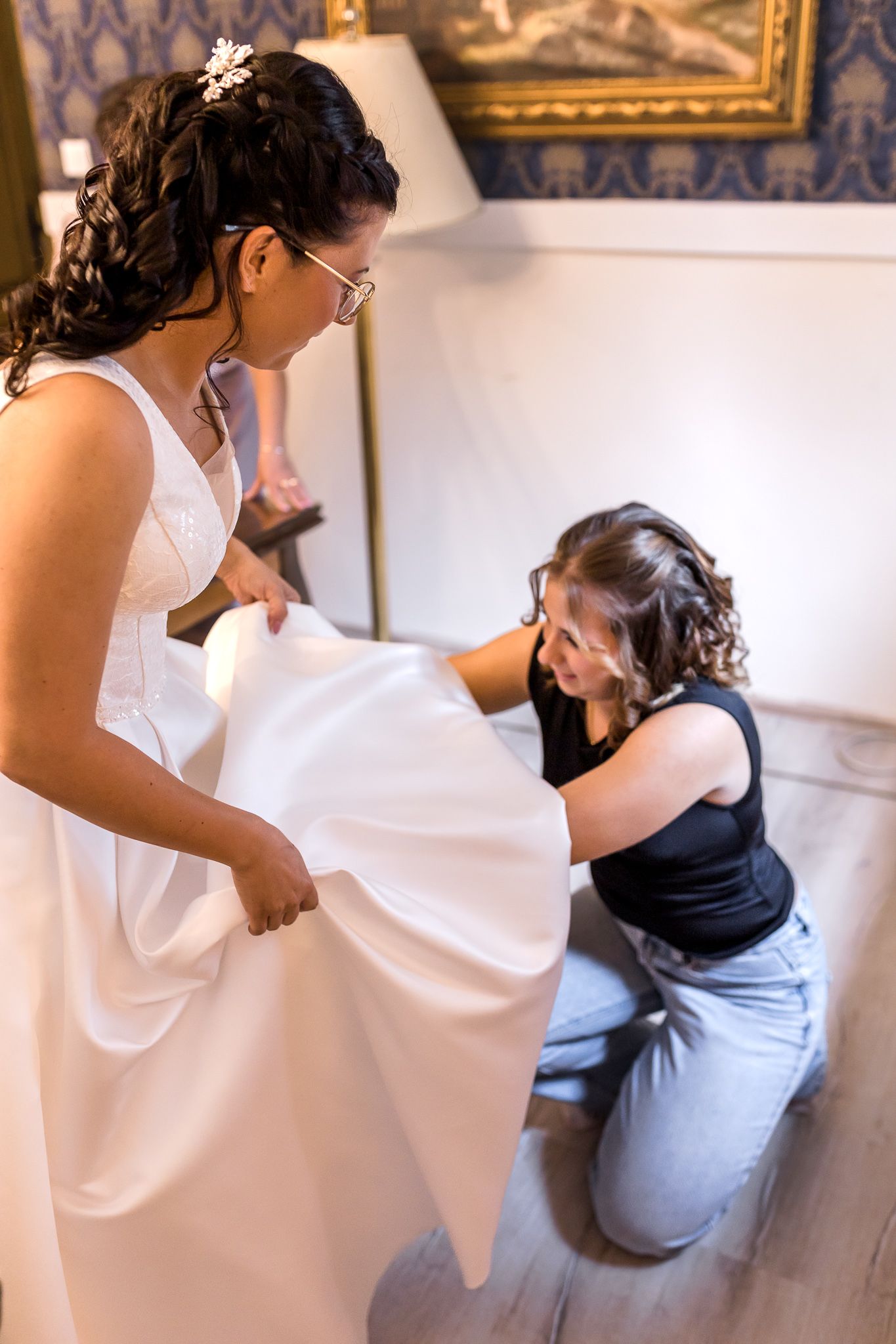 A sequence showing someone in a white top and light blue jeans crouching down in an elegant room setting.