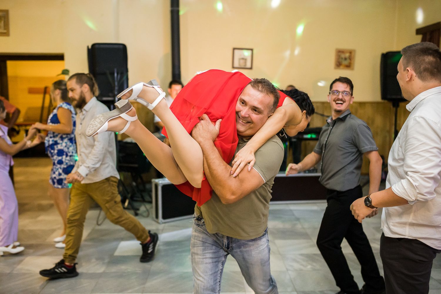 Group of people dancing and having fun at a social dance event in a bright indoor space.