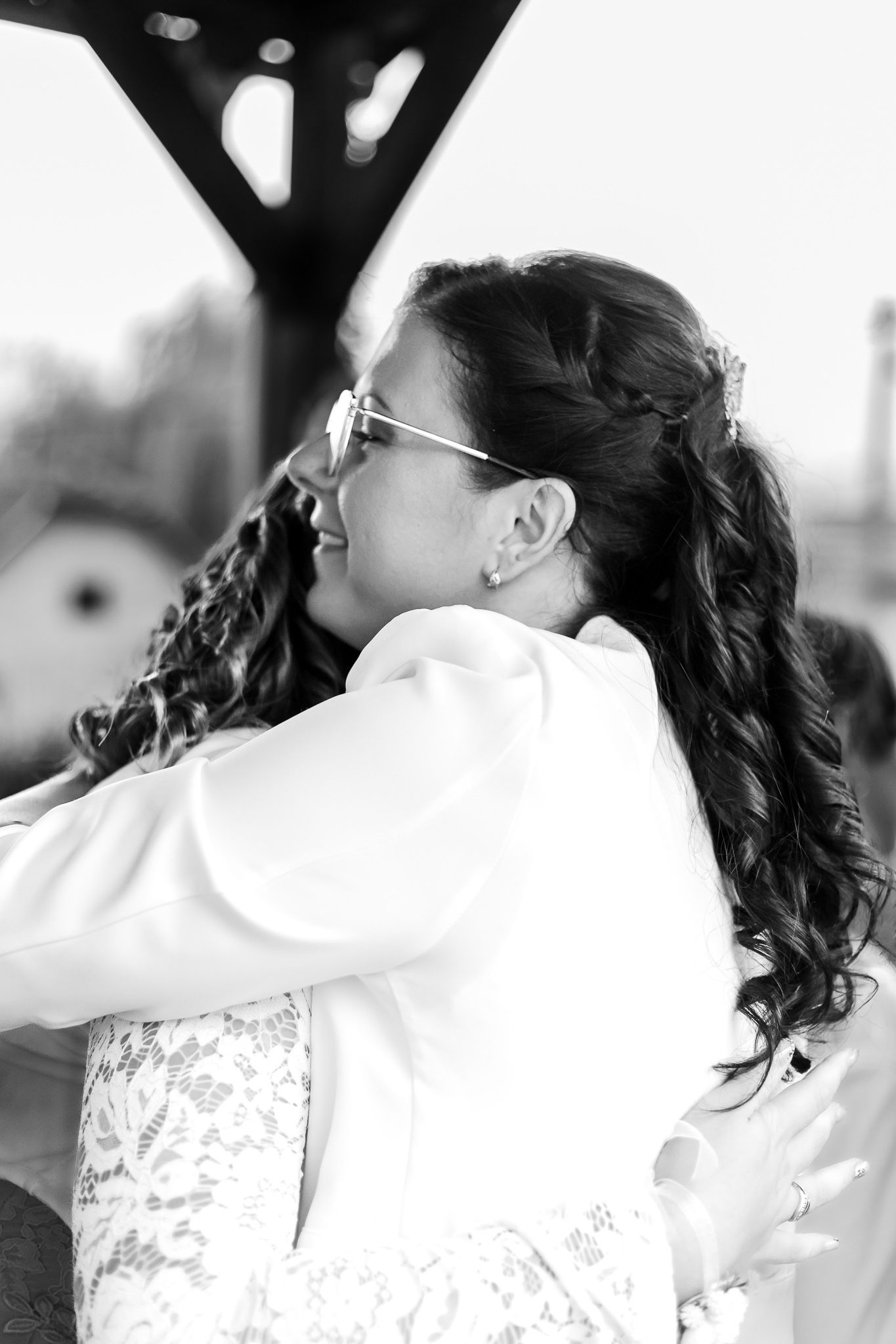 A sequence of black and white photos showing a couple in wedding attire sharing a romantic kiss.