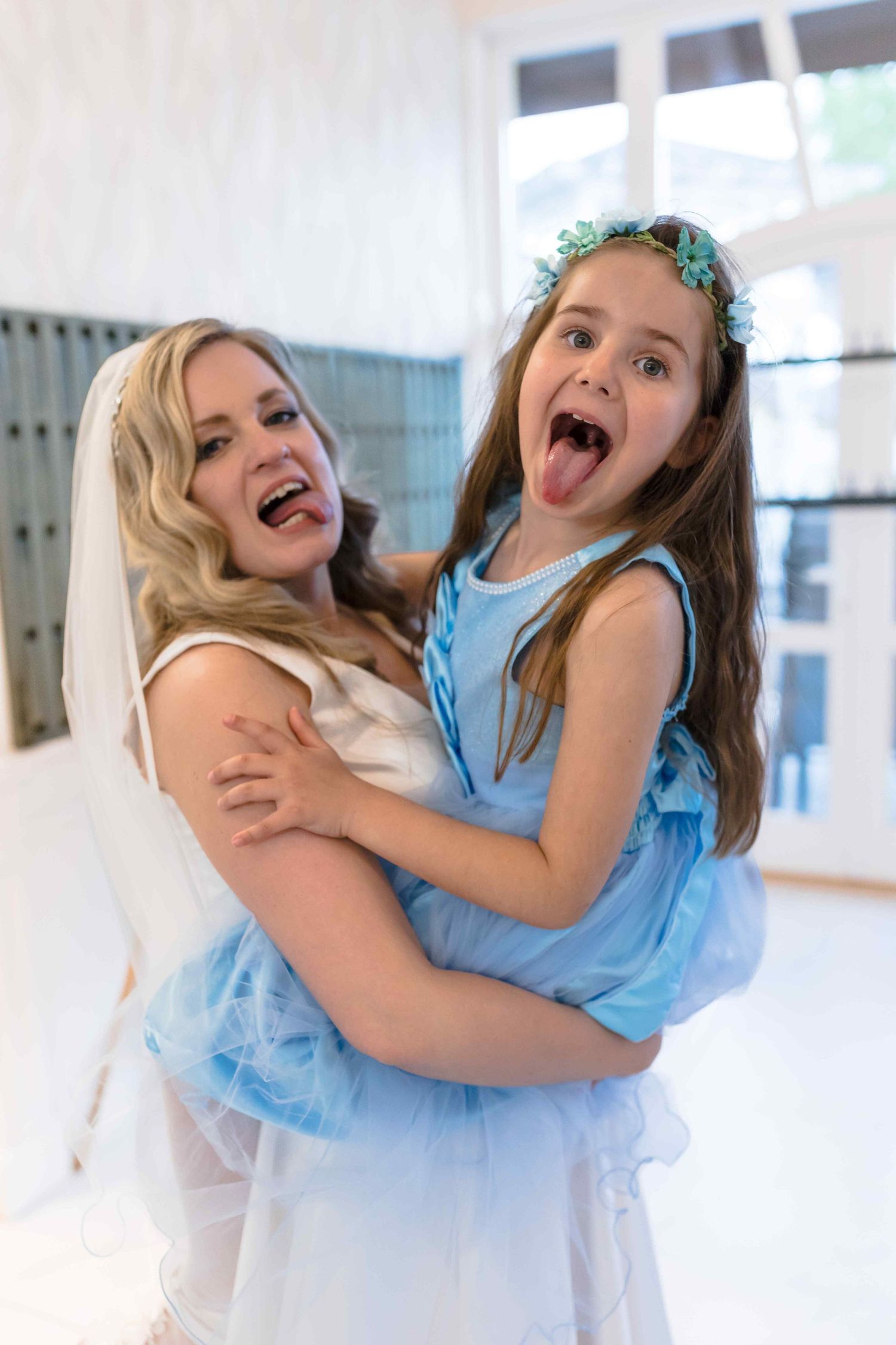 A joyful moment shared between two people wearing blue and white outfits at a special celebration.
