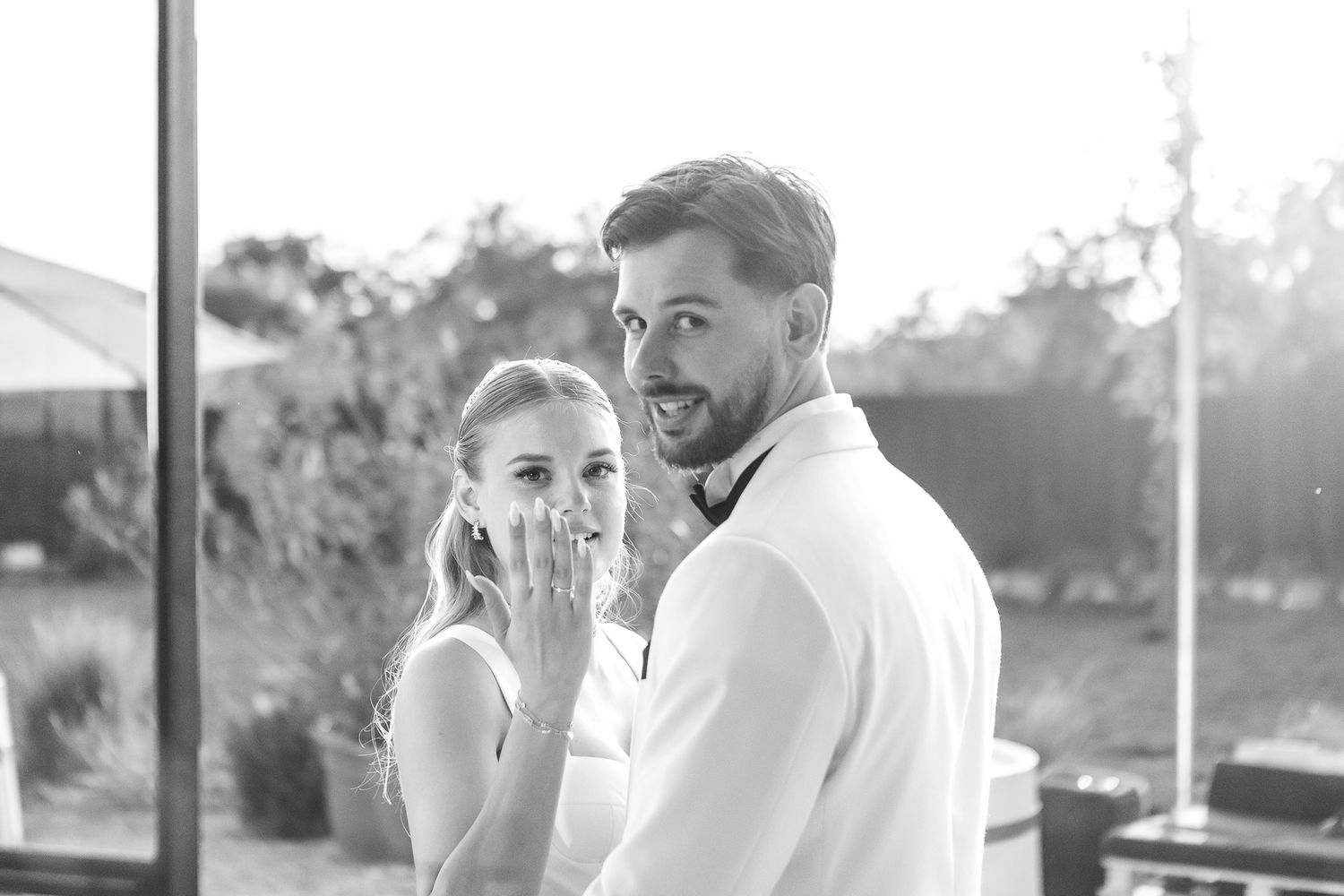 Wedding couple sharing intimate moment during sunset reception.