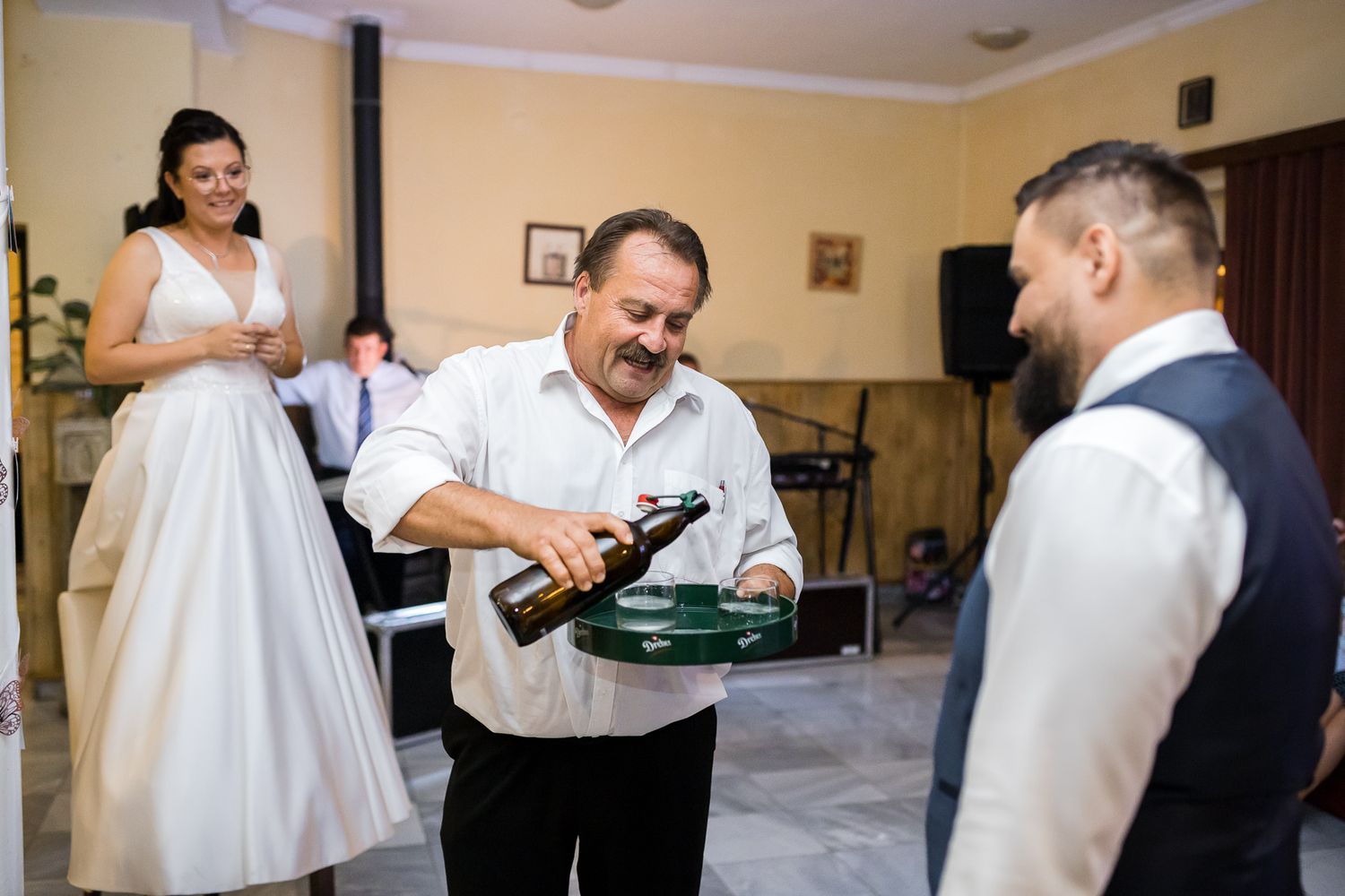 A series of wedding preparation moments showing people getting dressed and helping each other with formal attire.