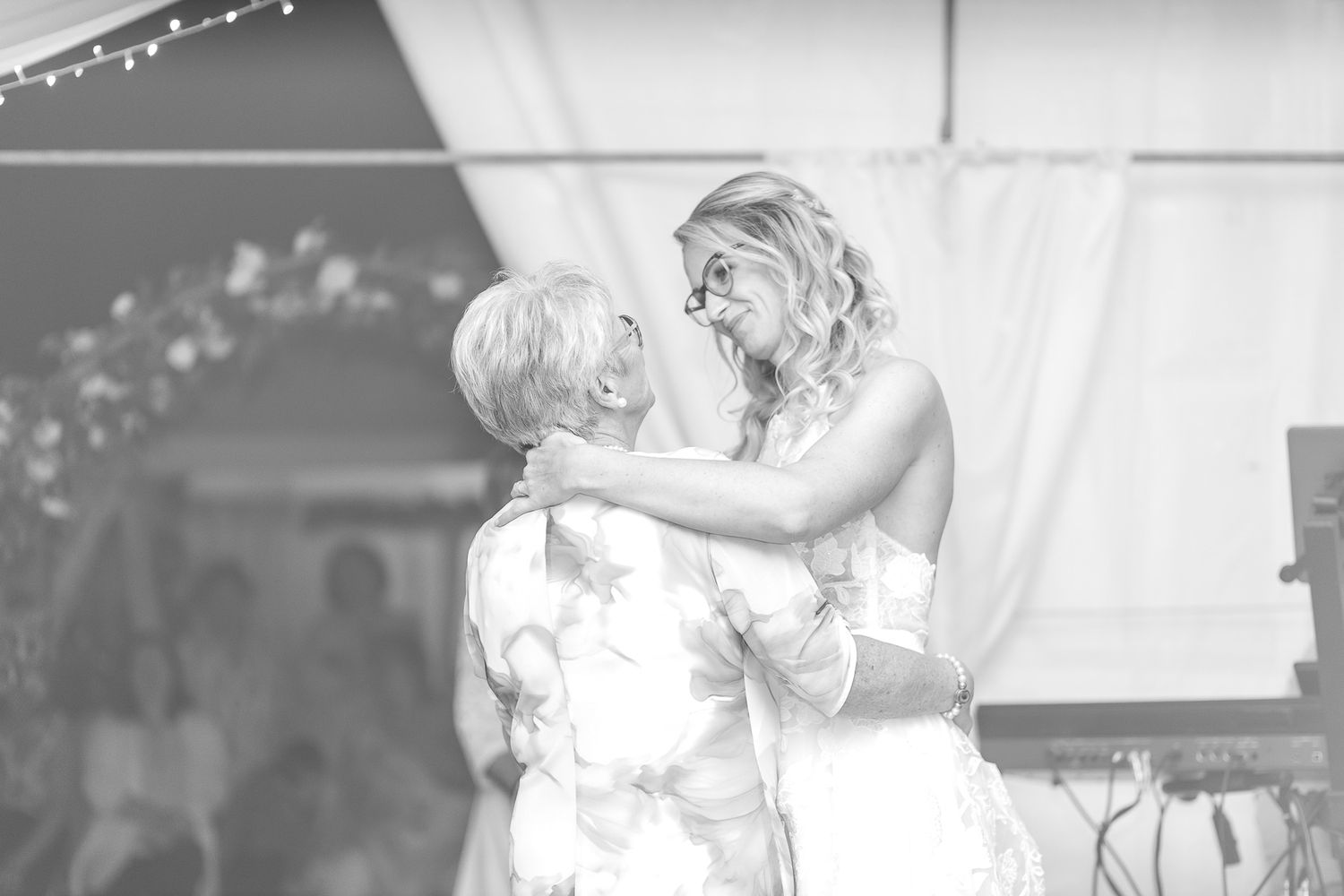 A black and white collage of wedding moments showing couples dancing and embracing at a reception celebration.