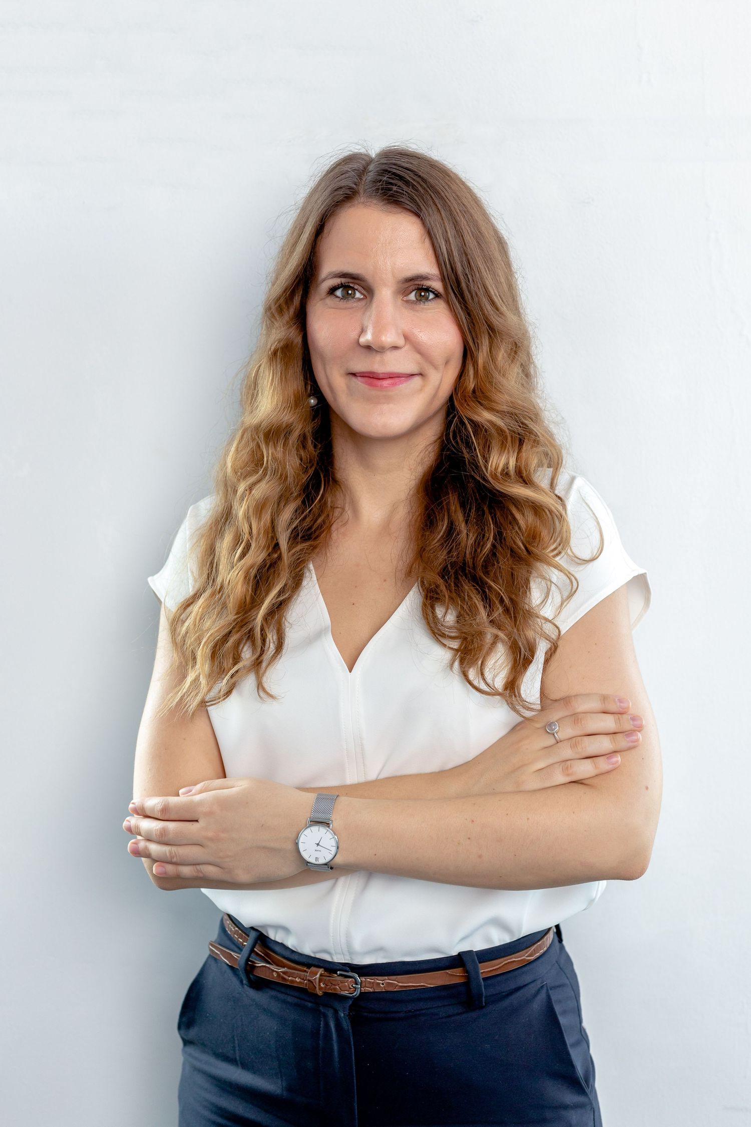 Business casual portraits against white wall showing professional attire with brown leather belt.