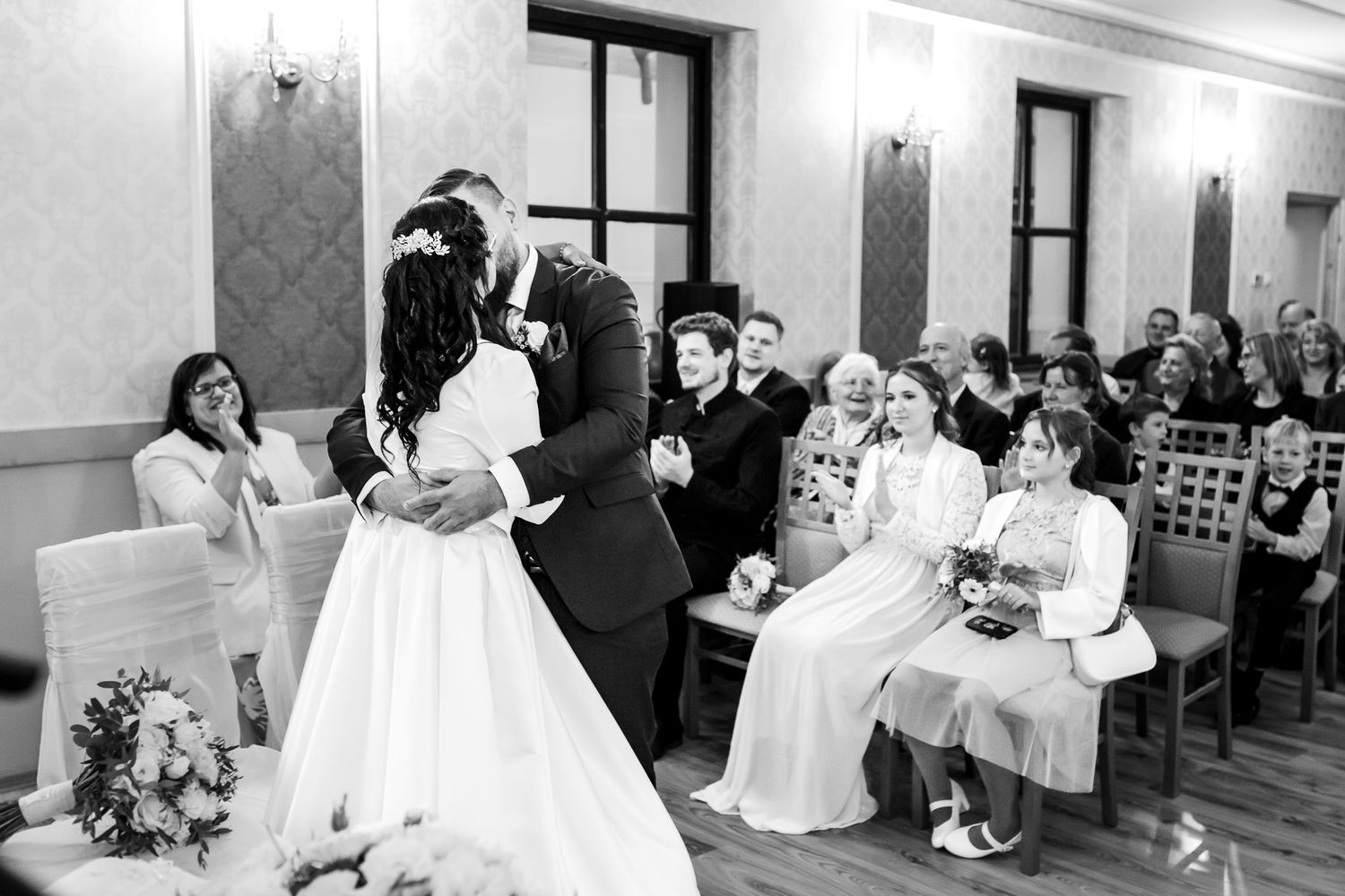 Black and white photo collage showing multiple wedding reception scenes with guests dining and dancing at tables.