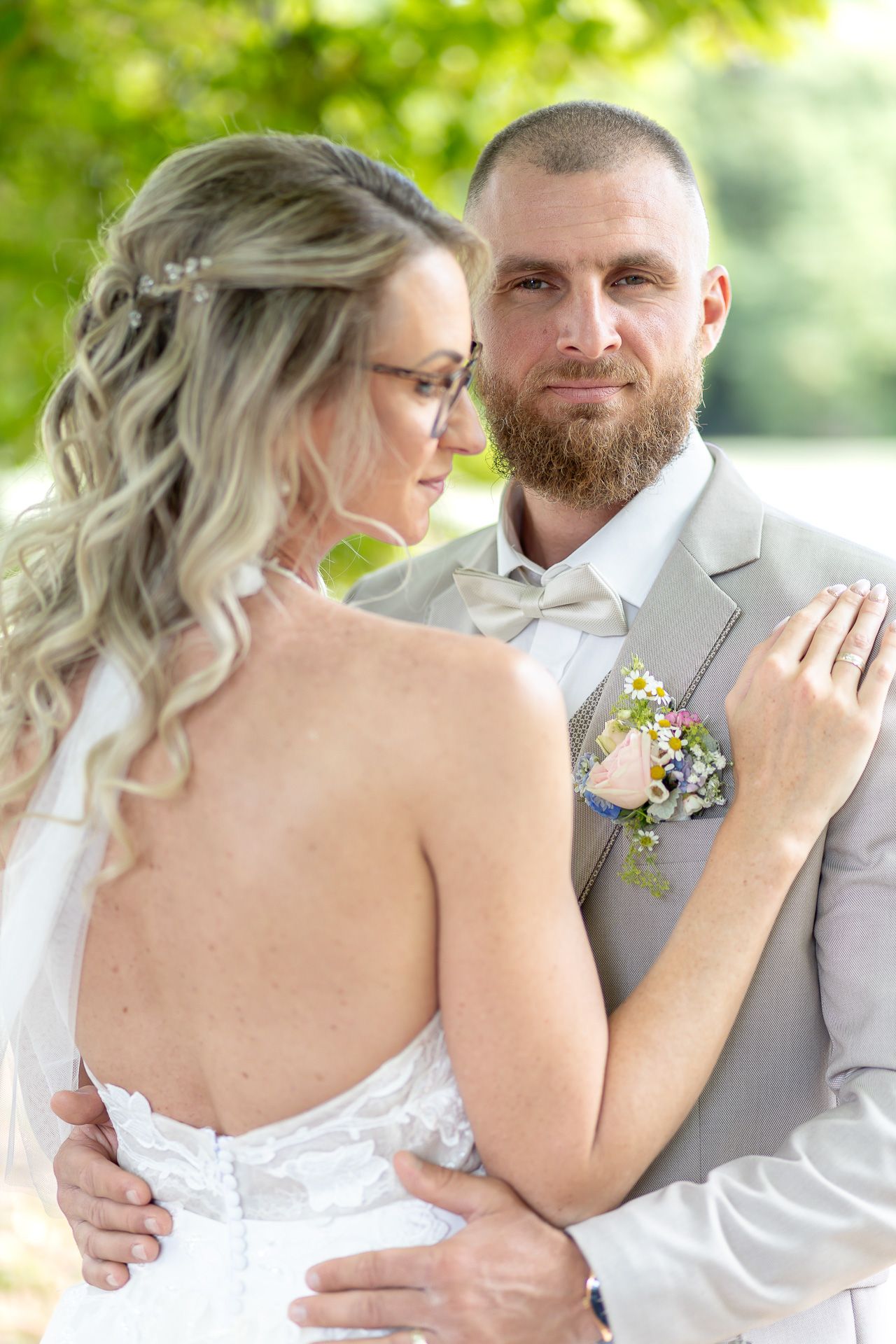 A romantic wedding photo collage showing tender moments between a bride in white and groom in gray outdoors.