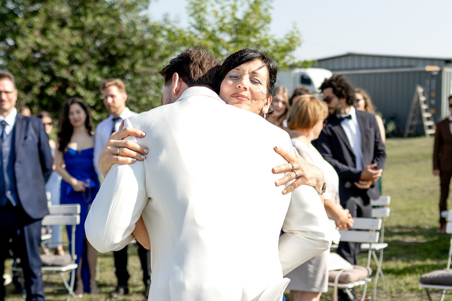 Wedding guests mingle and celebrate at casual outdoor reception venue.