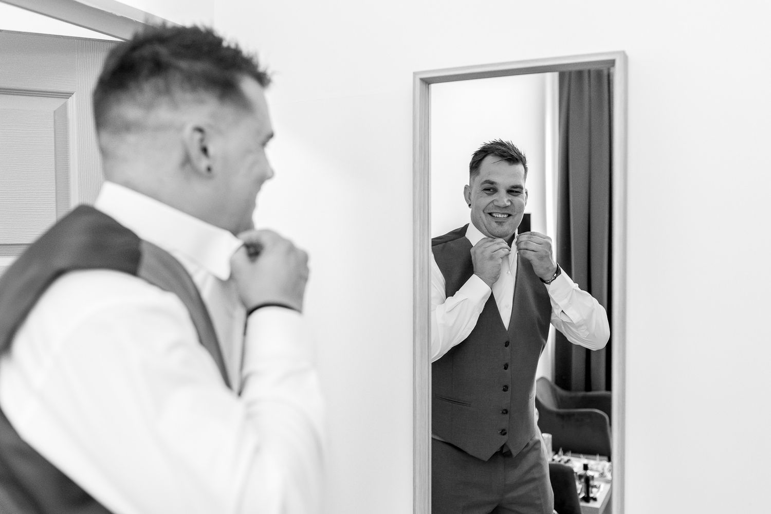 A series of black and white wedding preparation photos showing formal attire and getting ready moments.