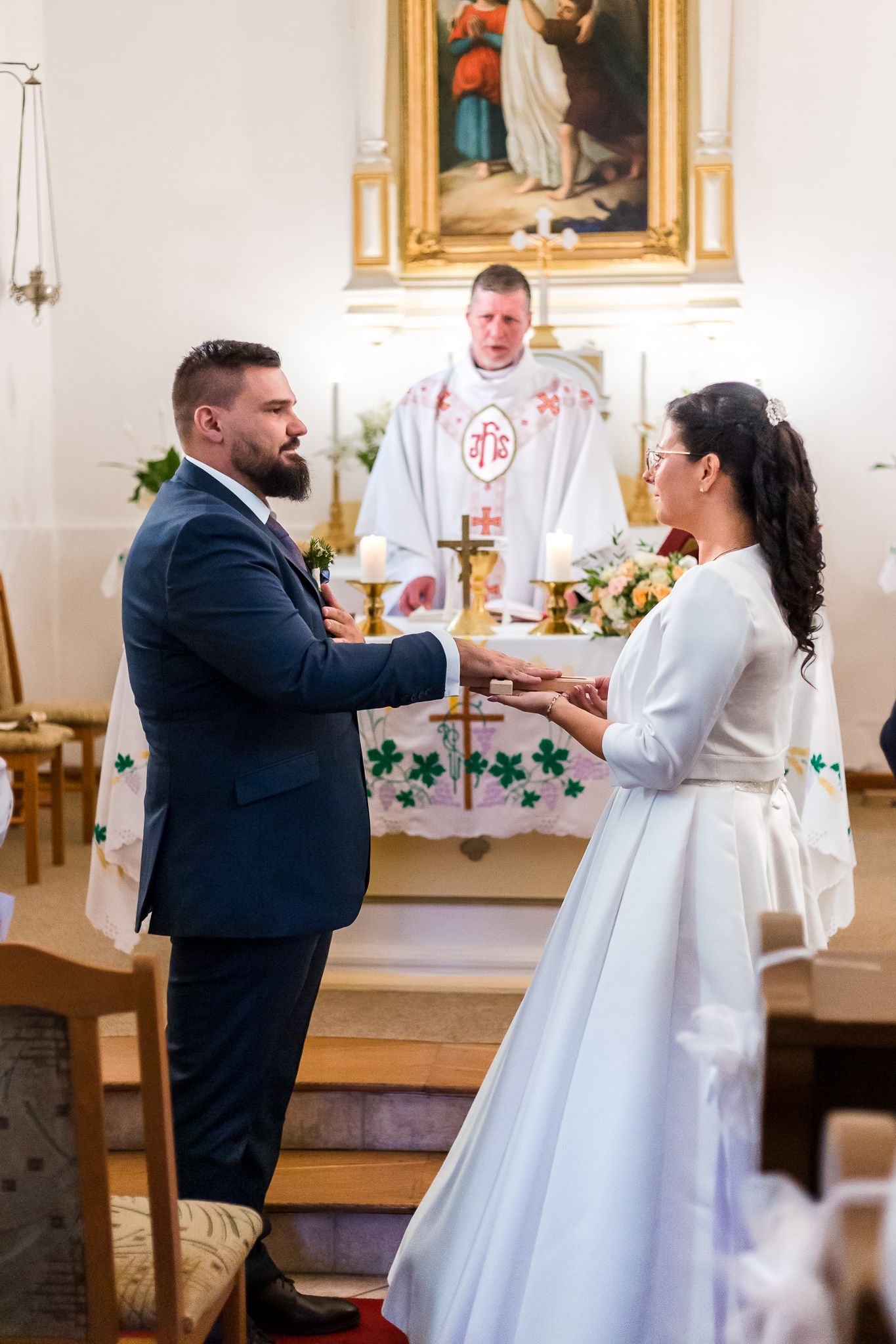 A series of photos showing communion being served at the altar during a Catholic church service.
