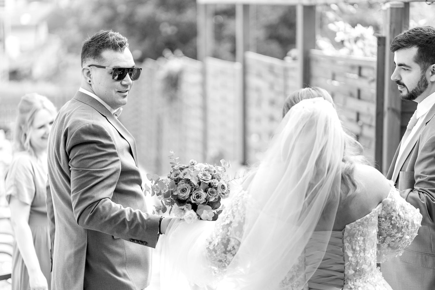 A series of black and white wedding photographs showing intimate moments between couples during their celebration.