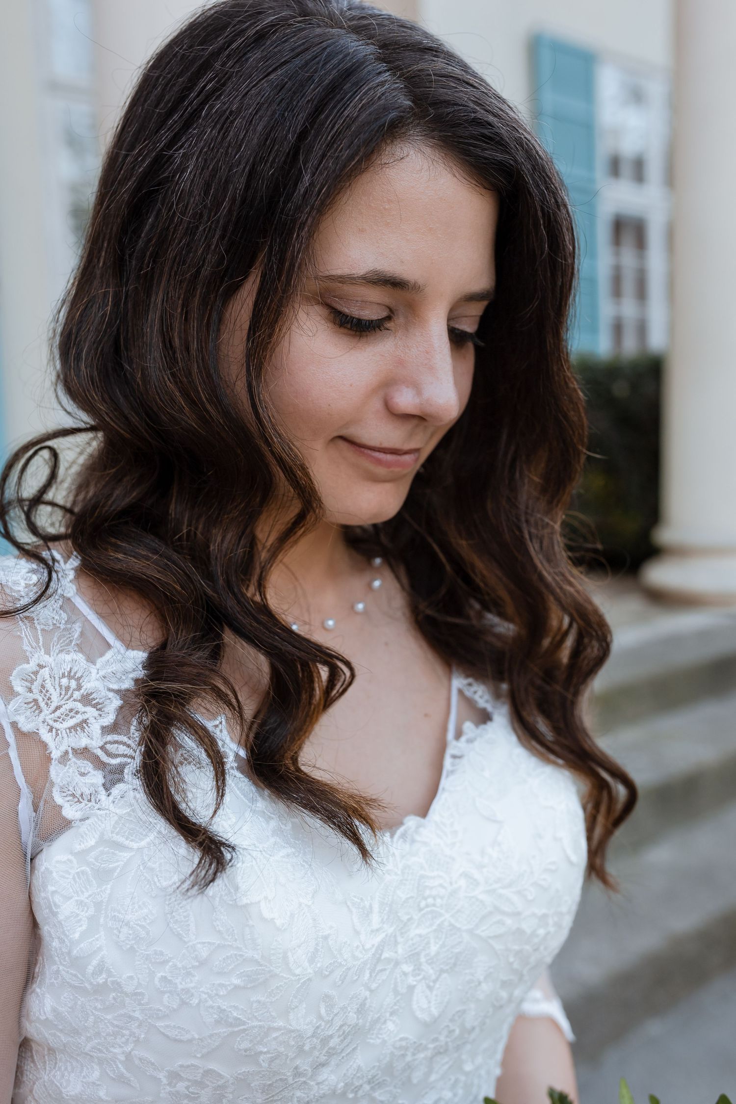 Three detail shots of a white lace wedding dress with delicate straps and floral embroidery details.