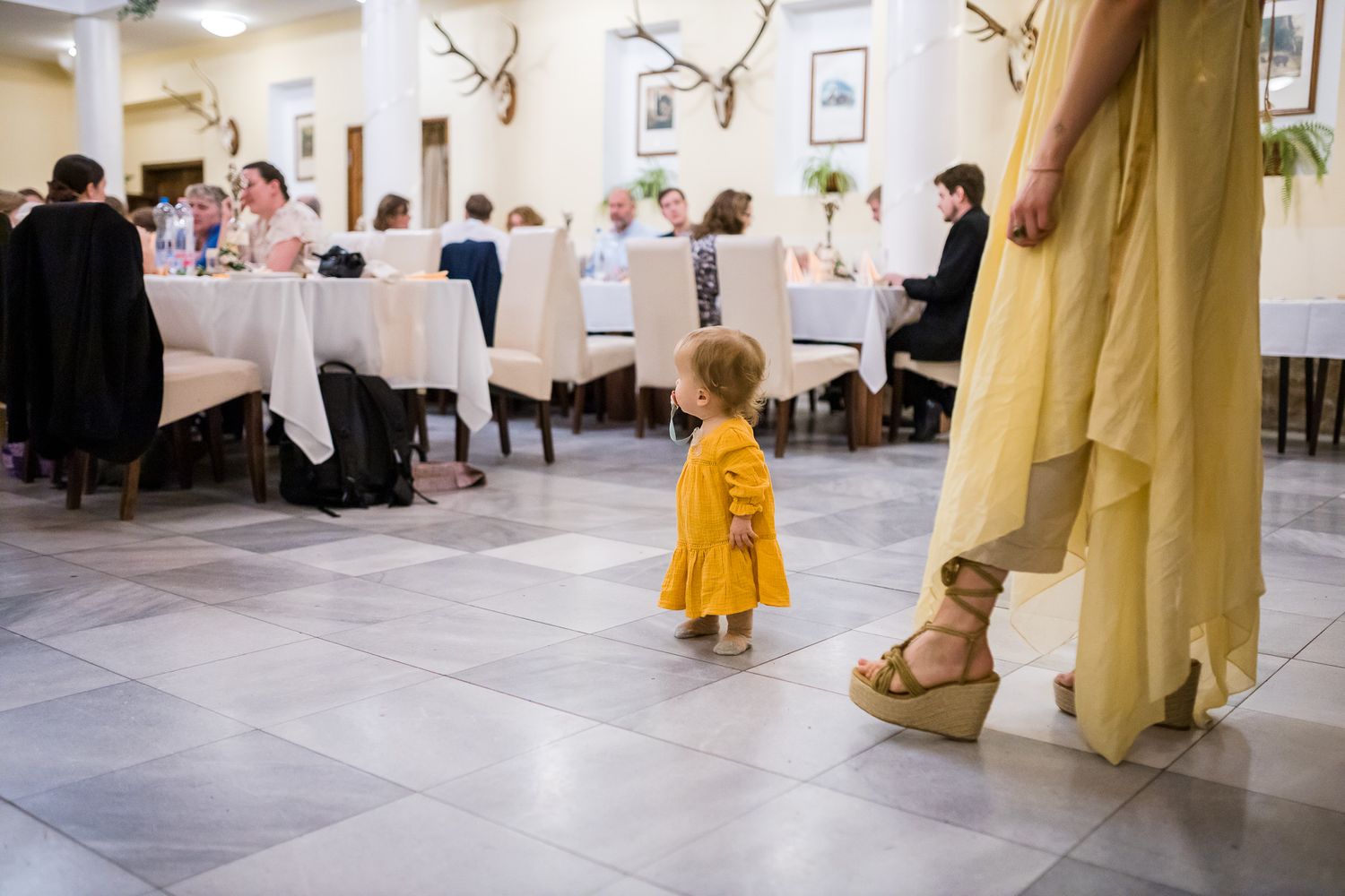 People dining in an elegant restaurant with white tablecloths and classic decor visible through multiple connected frames.