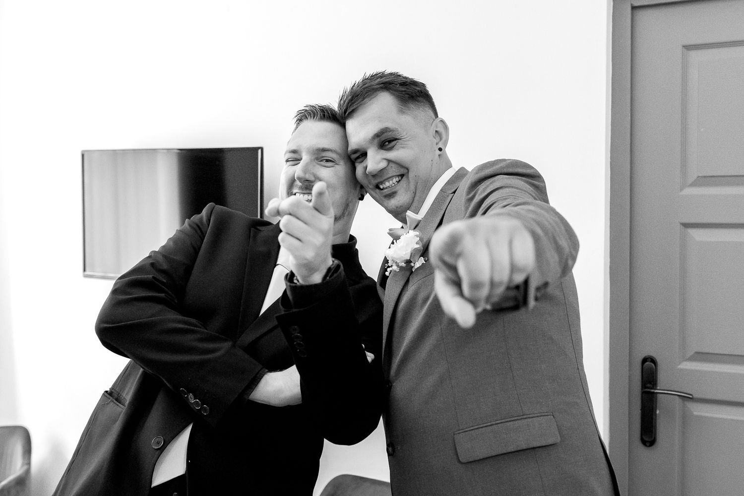 Black and white photo collage showing joyful candid moments of laughter and camaraderie.