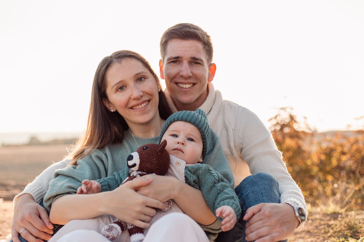 Natural light family portrait session with mountain views in background.