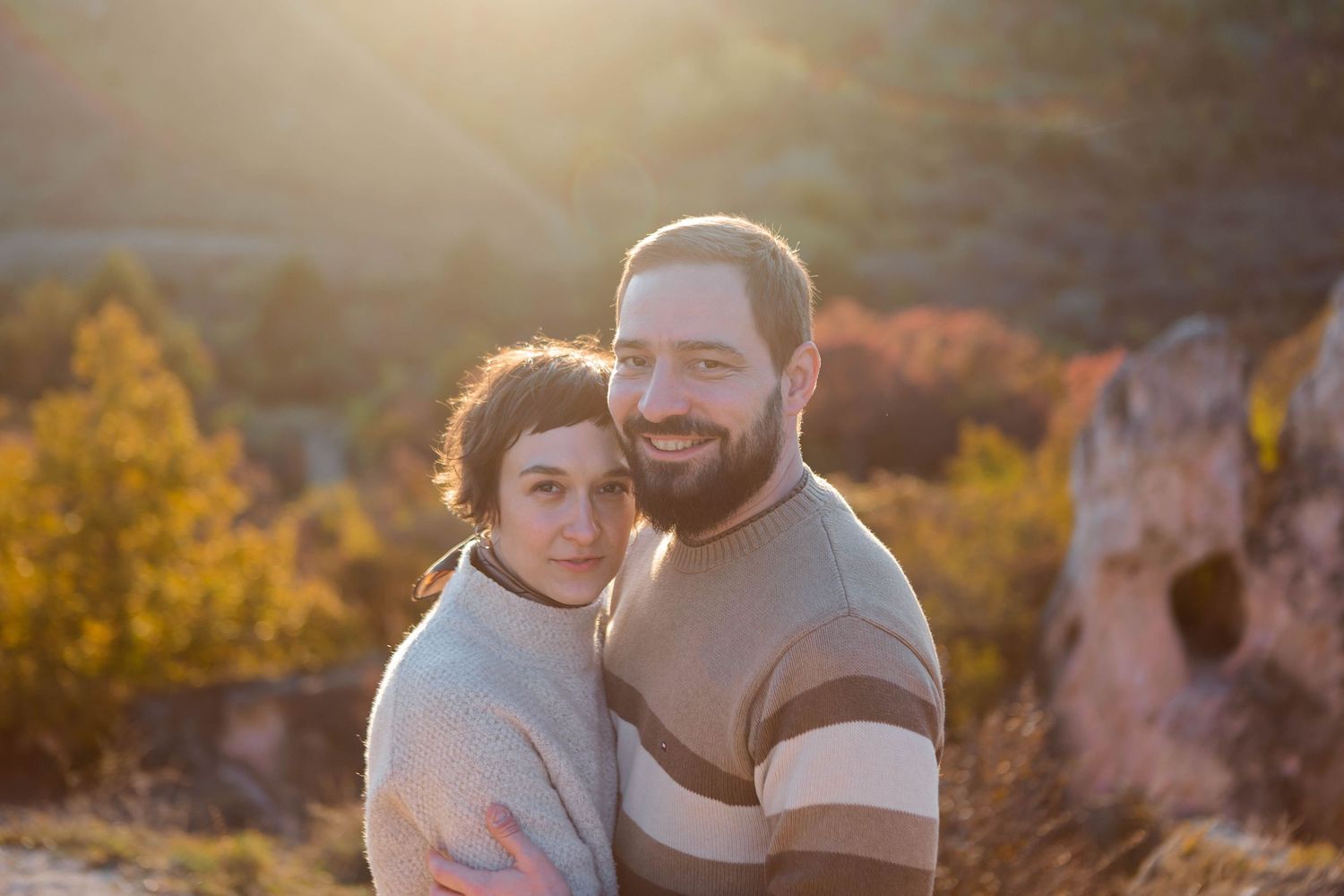 Candid family portrait session outdoors with warm autumn lighting.
