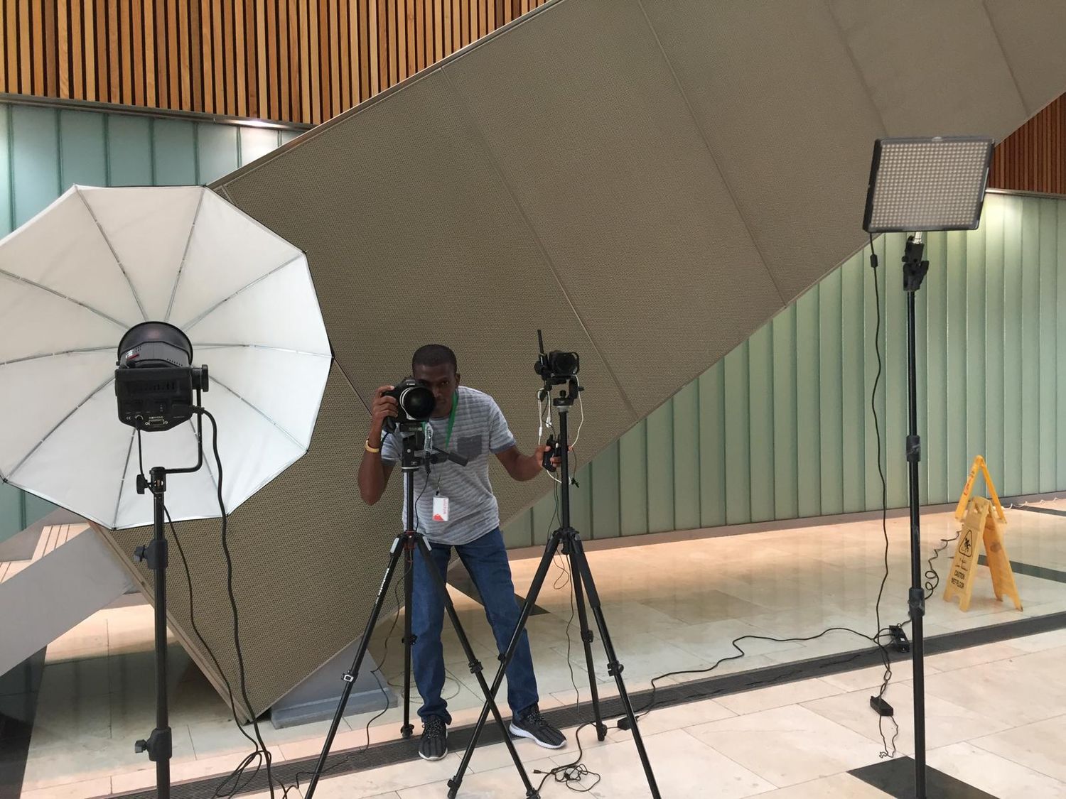 Professional photography setup with lighting equipment and camera gear in studio.