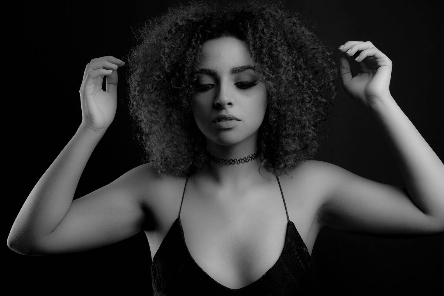 Dramatic black and white portraits highlighting natural curly hair texture.