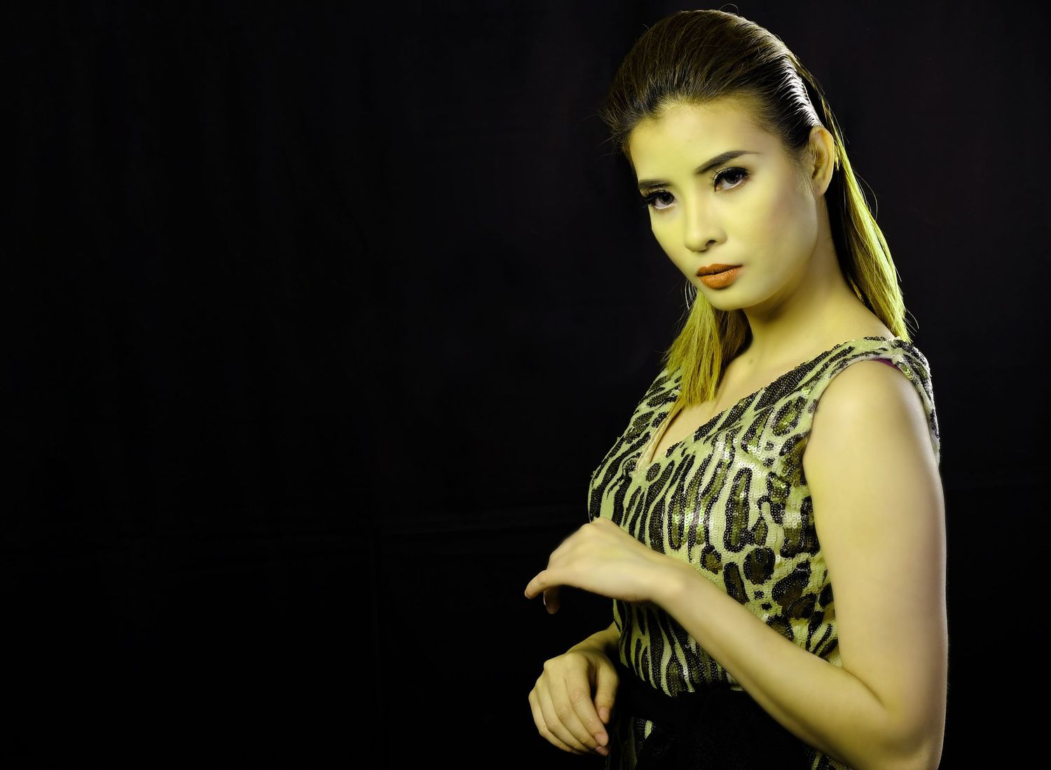 Side-view fashion portraits with dramatic lighting against black background.