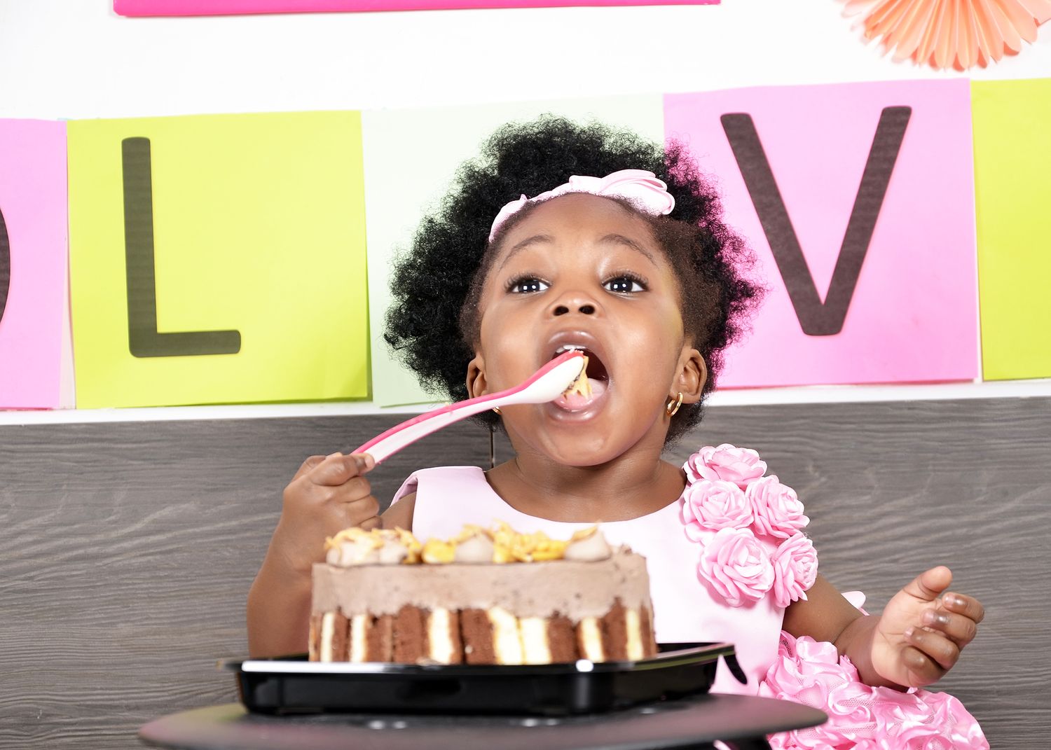 A joyful birthday celebration moment with cake and colorful decorations.