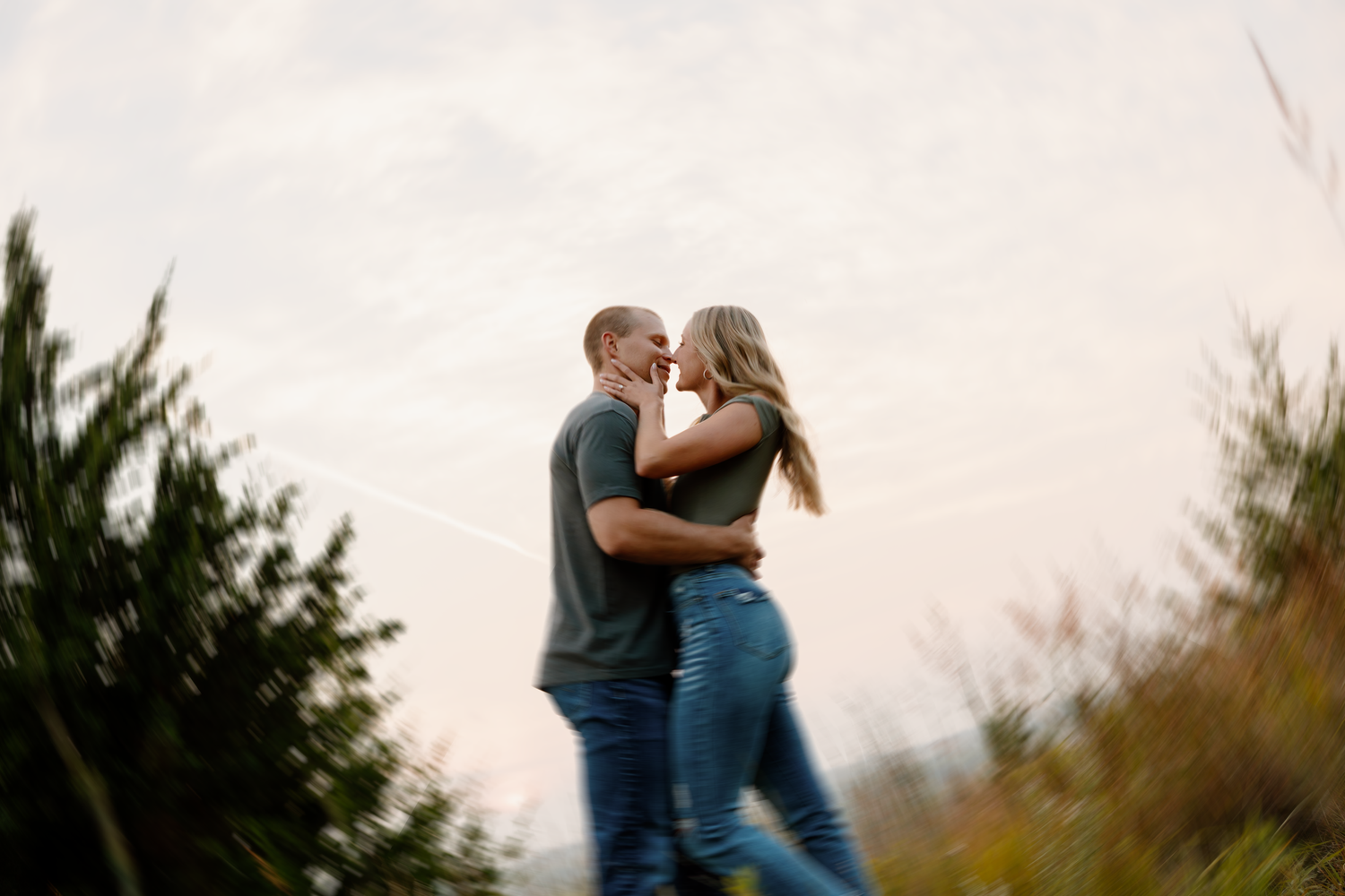 A couple shares intimate moments together in a moody outdoor photo sequence at sunset.
