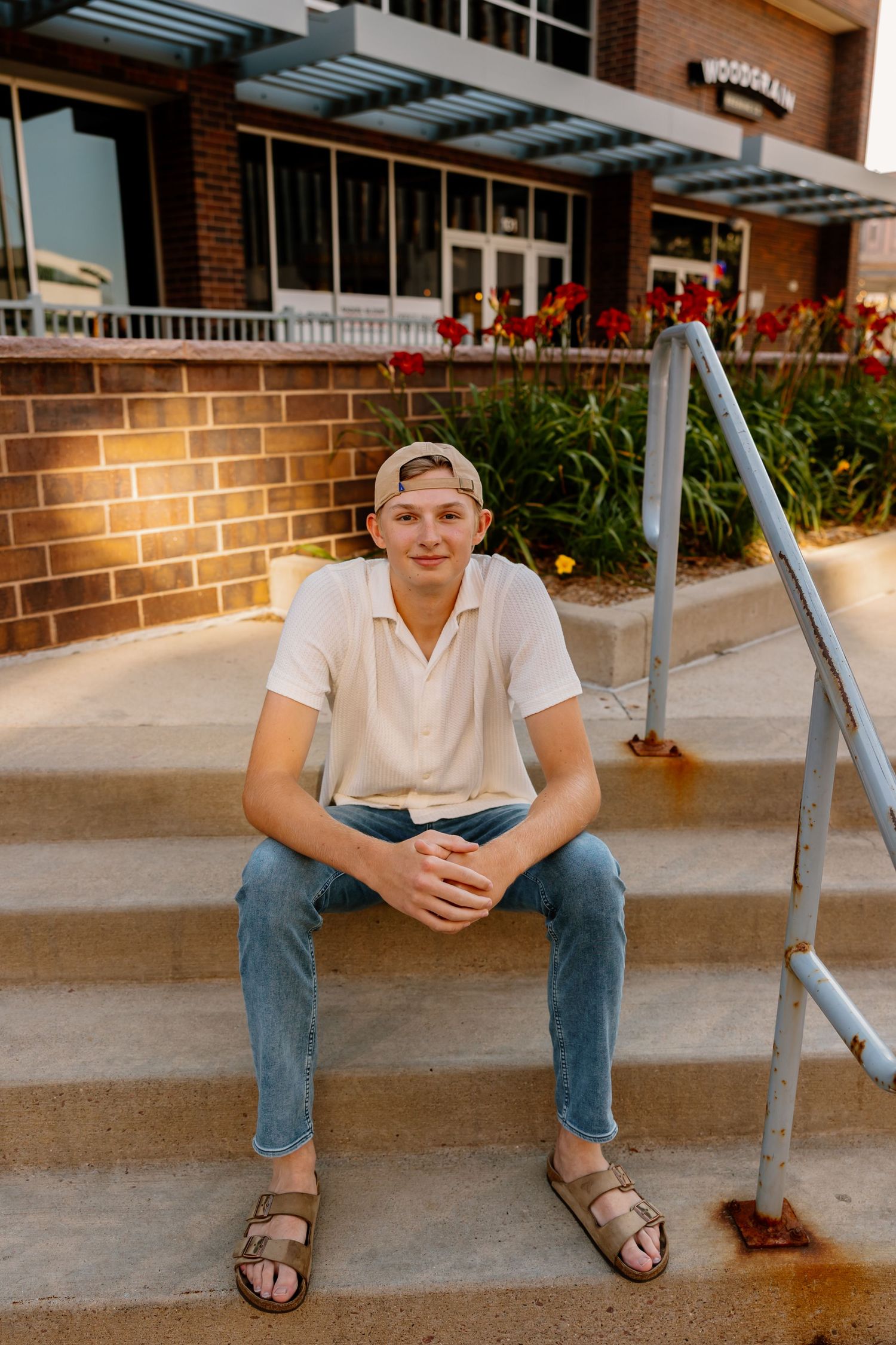 Candid shots of someone sitting on concrete steps wearing jeans and sandals.