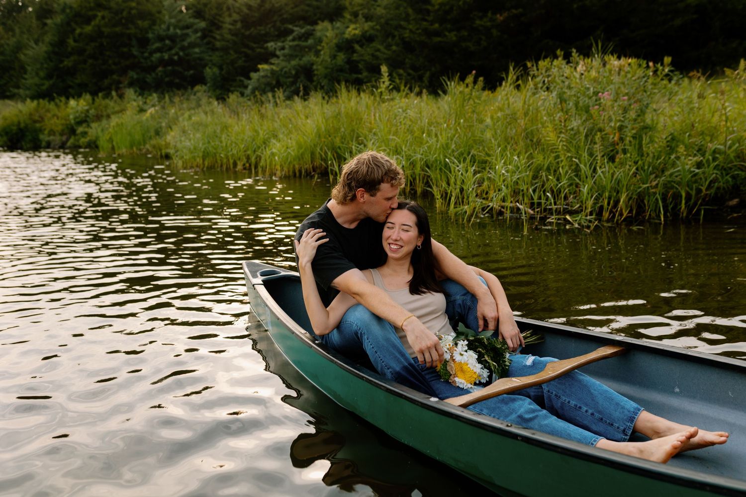 Couple enjoys peaceful moment together in green canoe on serene lake.
Sioux Falls Photographer  
Evermore Photo Co