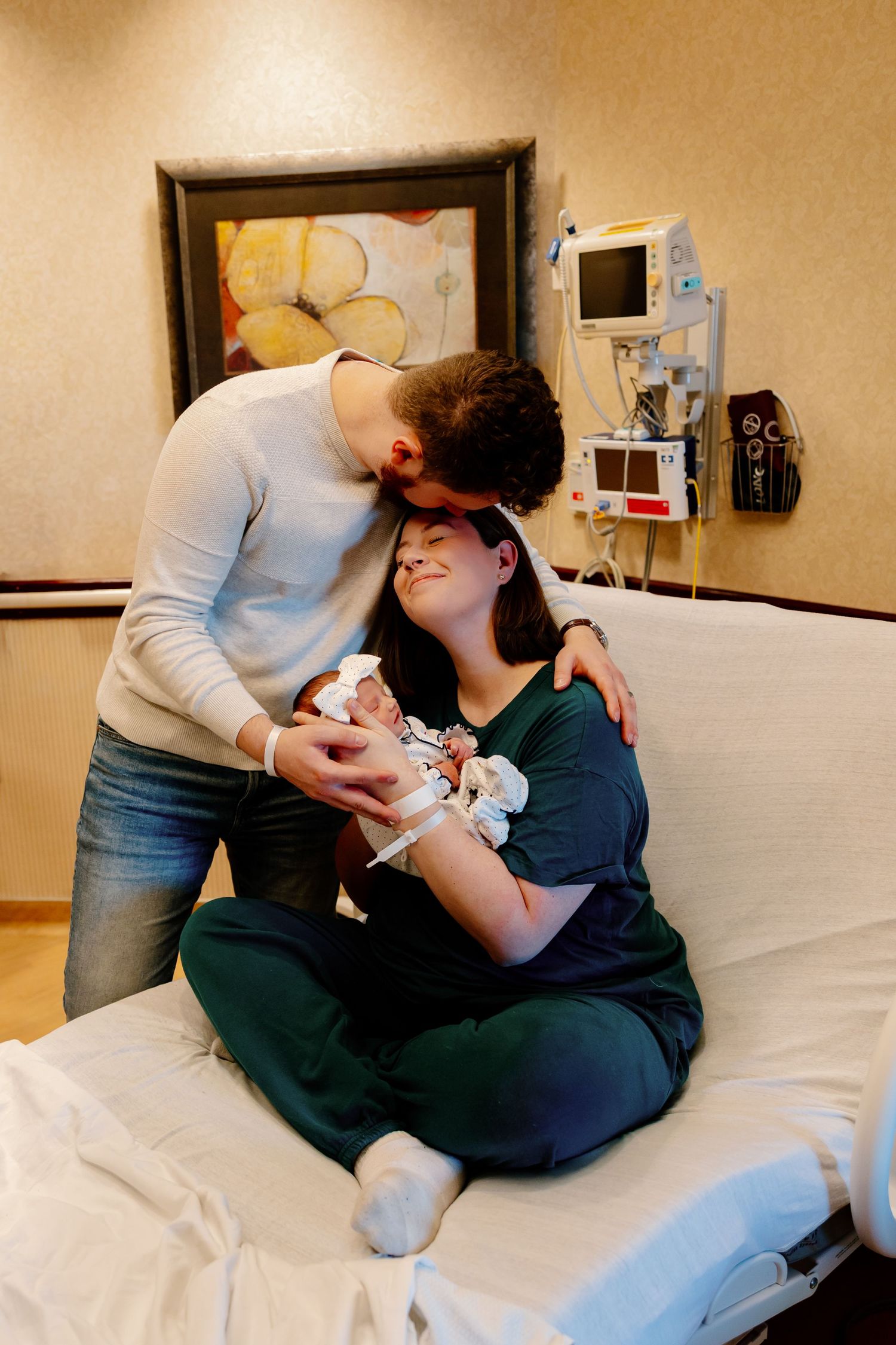 A series of progressive images showing a parent bonding with a newborn baby in a hospital room. Riley Ro Photo Sioux Falls, SD