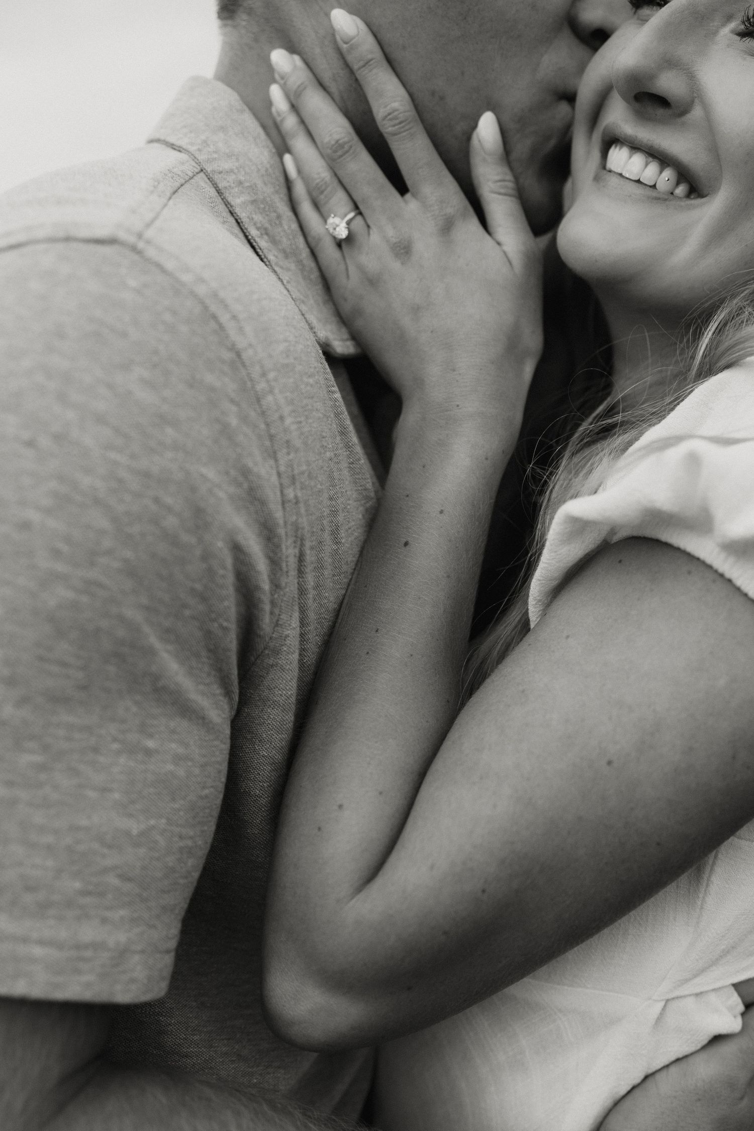 Close-up portrait of couple sharing intimate laughing moment together.