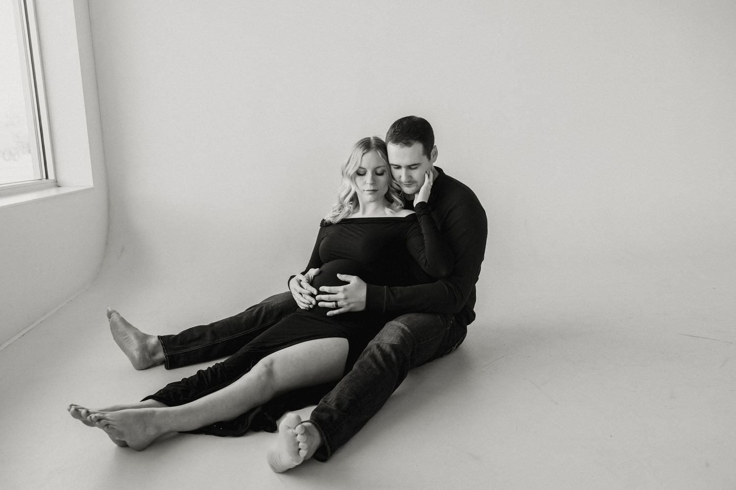 A sequence of black and white photographs depicting two people laying down together in various poses.
Riley Ro Photo Sioux Falls, SD