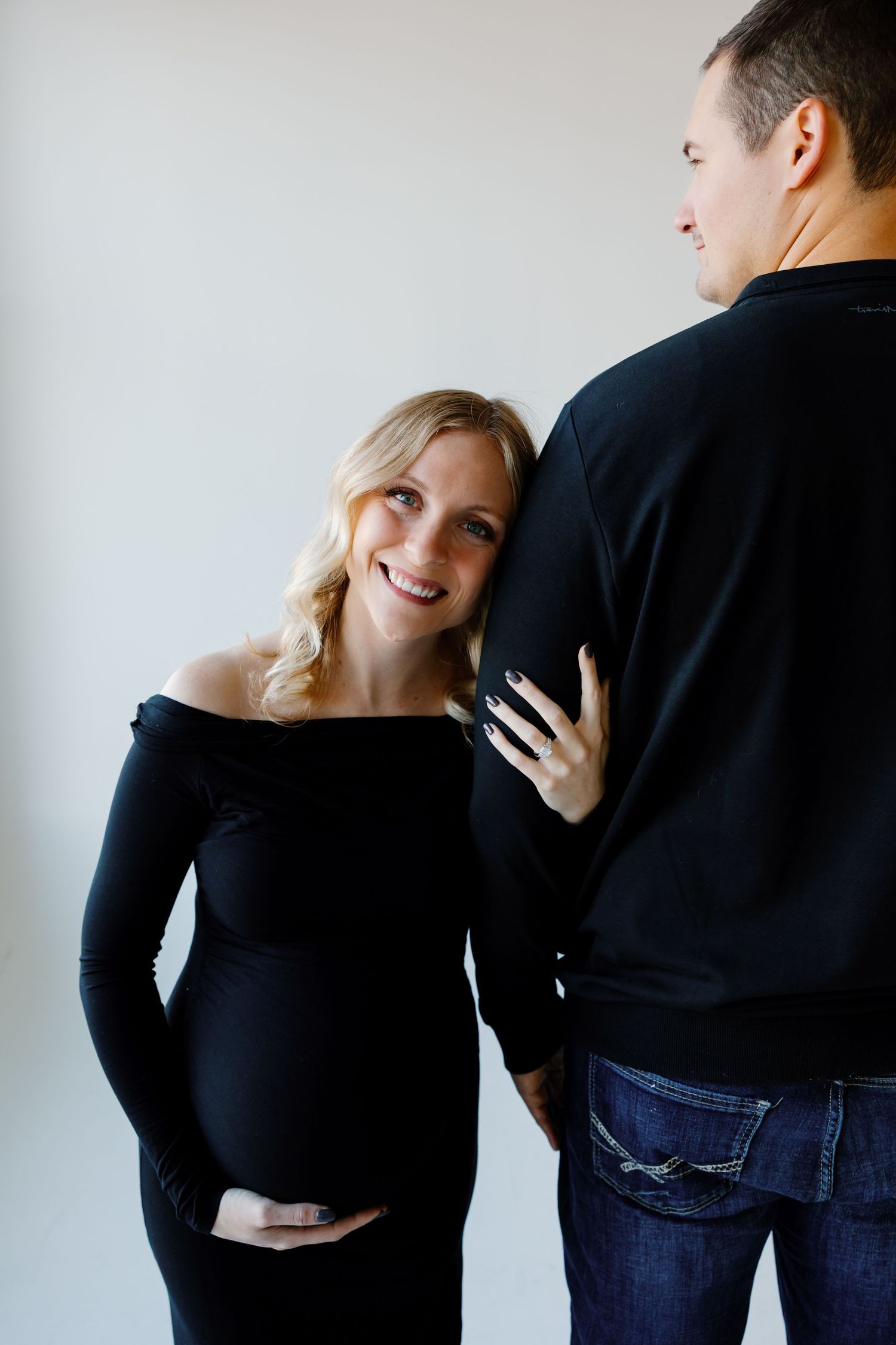 A couple in black and denim embraces in a series of romantic poses against a white background. iley Ro Photo Sioux Falls, SD