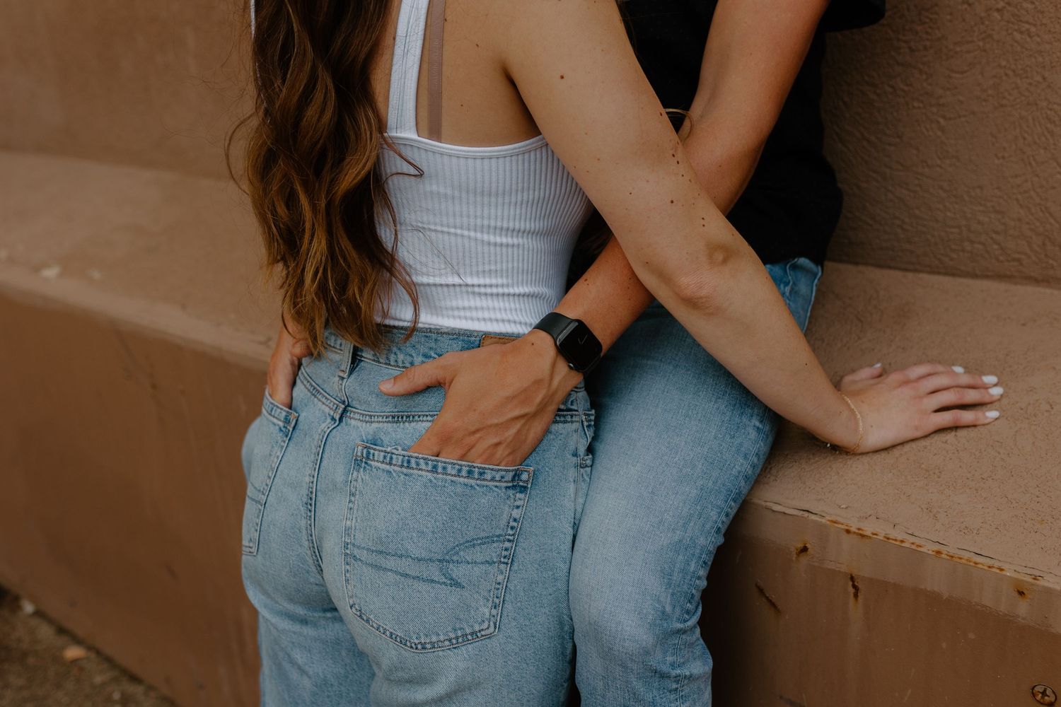 Close-up shot of two people in denim jeans embracing against a wall.
Sioux Falls Photographer  
Evermore Photo Co